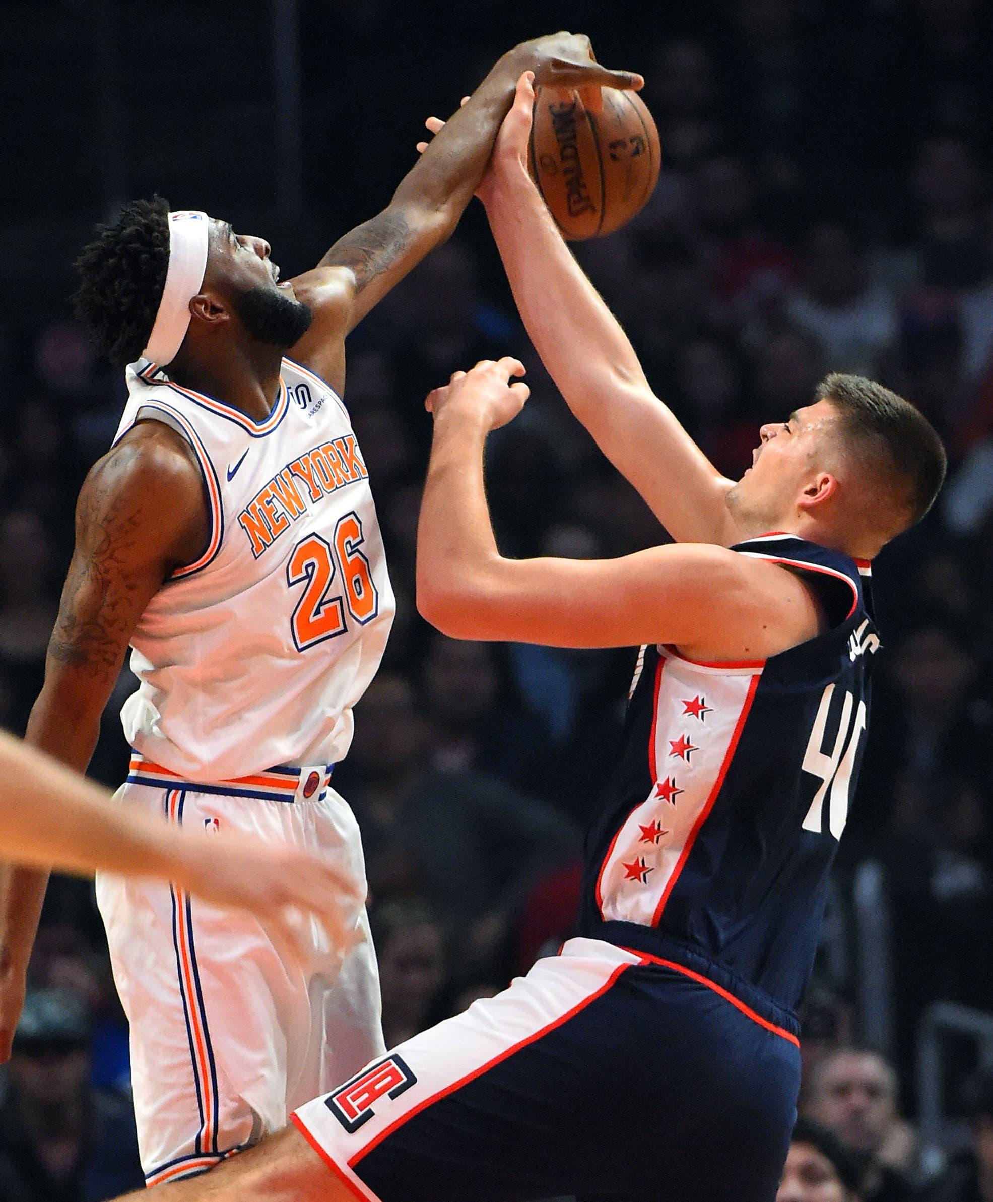 New York Knicks center Mitchell Robinson blocks a shot by Los Angeles Clippers center Ivica Zubac in the first half of the game at Staples Center. / Jayne Kamin-Oncea/USA TODAY Sports