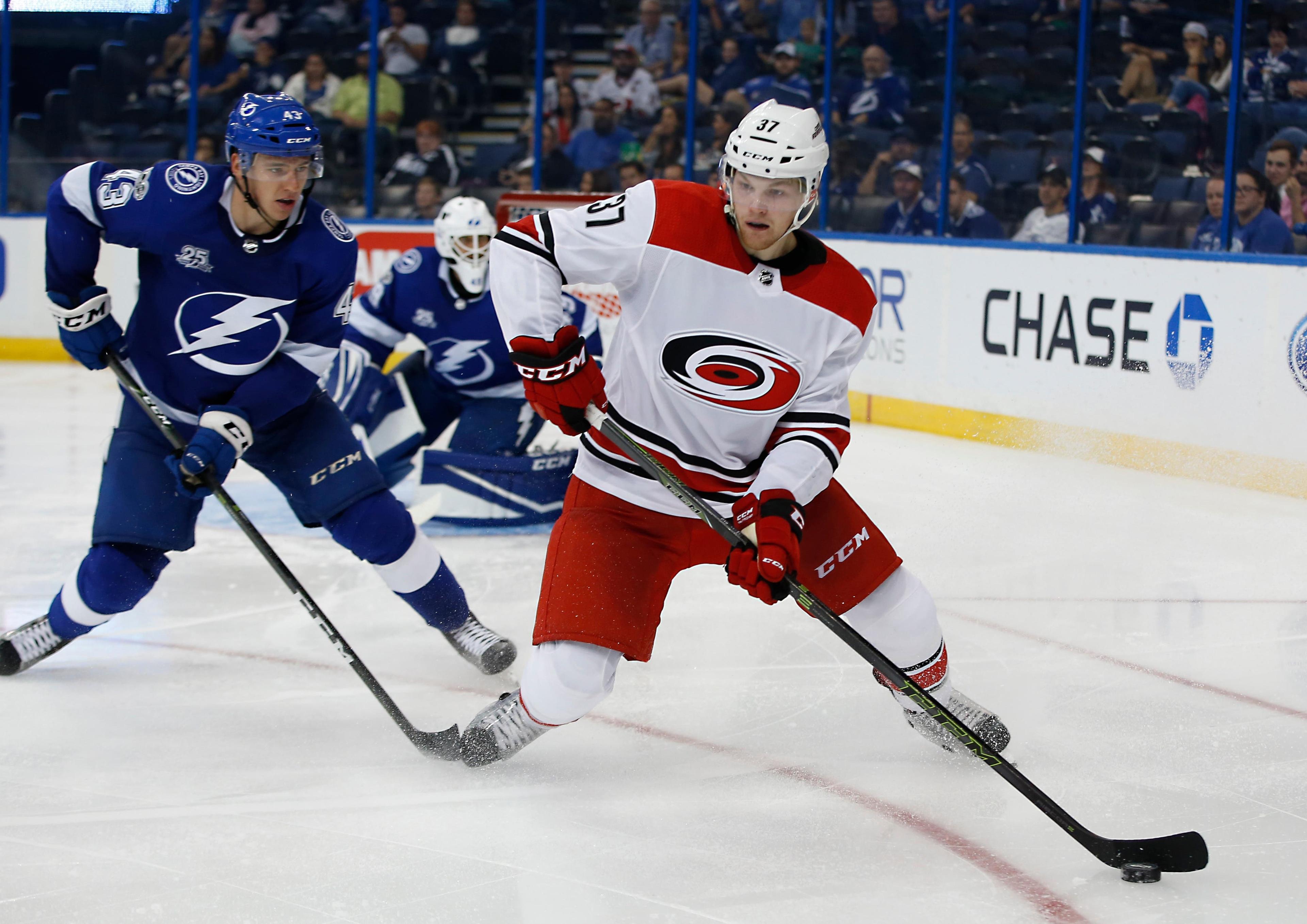 Sep 19, 2017; Tampa, FL, USA; Tampa Bay Lightning defenseman Libor Hajek (43) pressures Carolina Hurricanes forward Warren Foegele (37) during the third period of a hockey game at Amalie Arena. Mandatory Credit: Reinhold Matay-USA TODAY Sports / Reinhold Matay