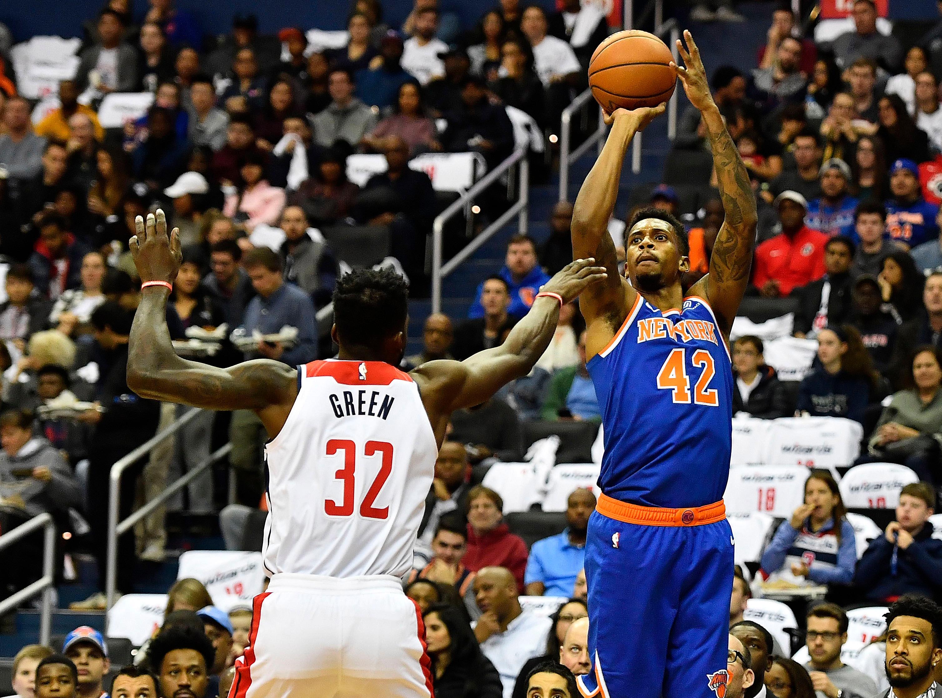 New York Knicks forward Lance Thomas shoots over Washington Wizards forward Jeff Green during the first half at Capital One Arena.