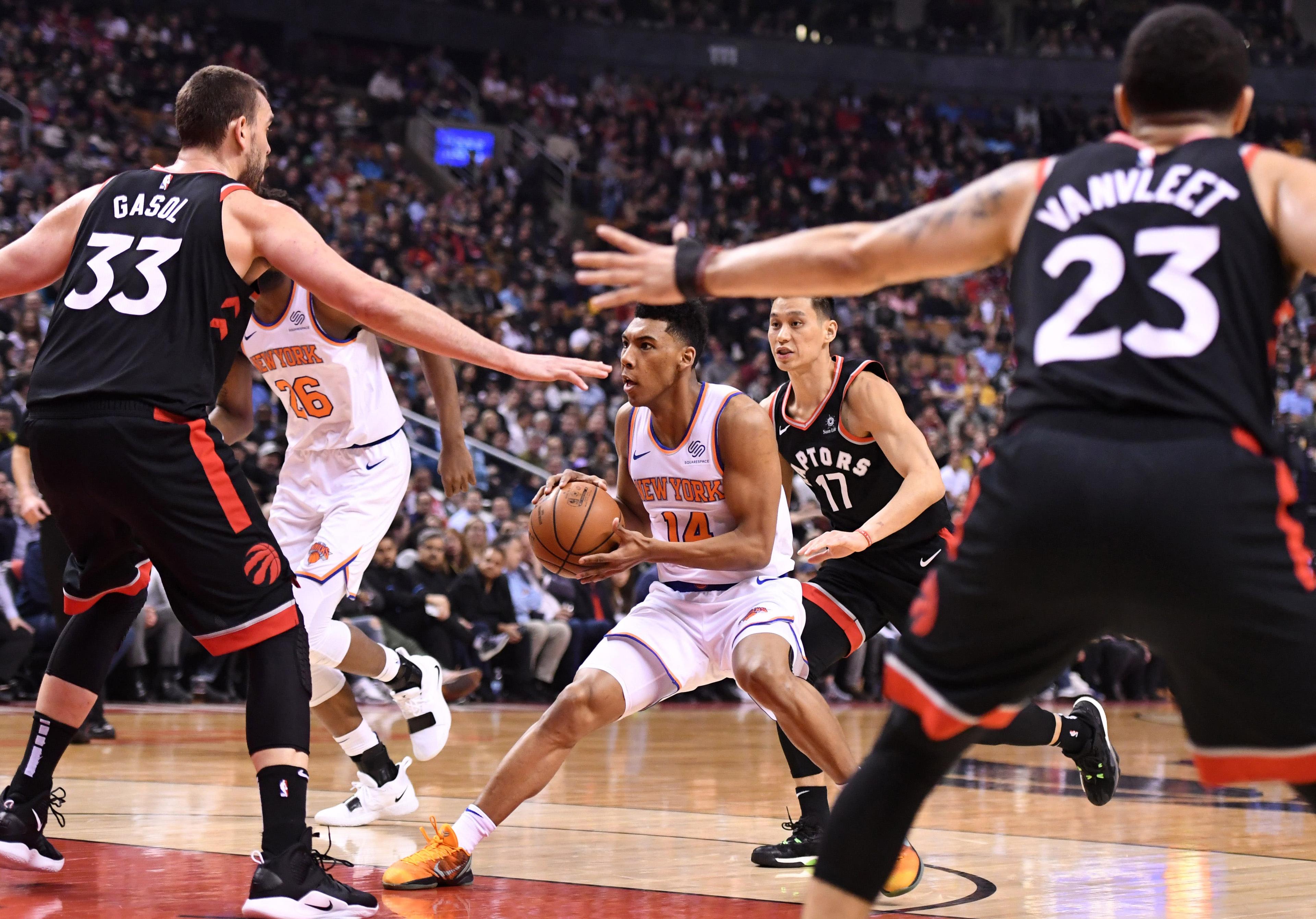 New York Knicks guard Allonzo Trier tries to drive against Toronto Raptors center Marc Gasol and guards Fred VanVleet and Jeremy Lin in the first half at Scotiabank Arena. / Dan Hamilton/USA TODAY Sports