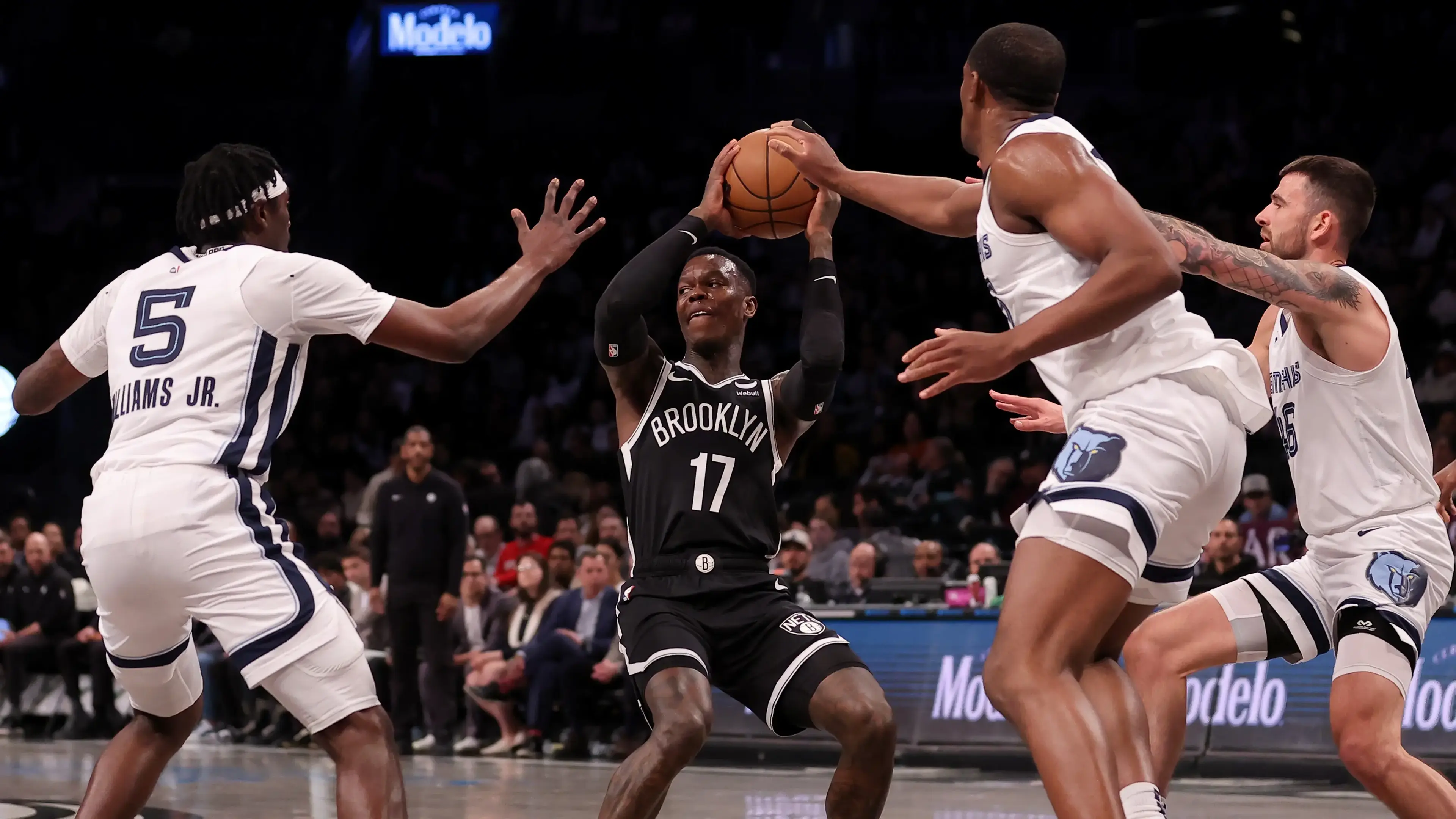 Brooklyn Nets guard Dennis Schroder (17) looks to pass the ball against Memphis Grizzlies guard Vince Williams Jr. (5) and center Trey Jemison (55) and guard John Konchar (46) during the first quarter at Barclays Center / Brad Penner - USA TODAY Sports
