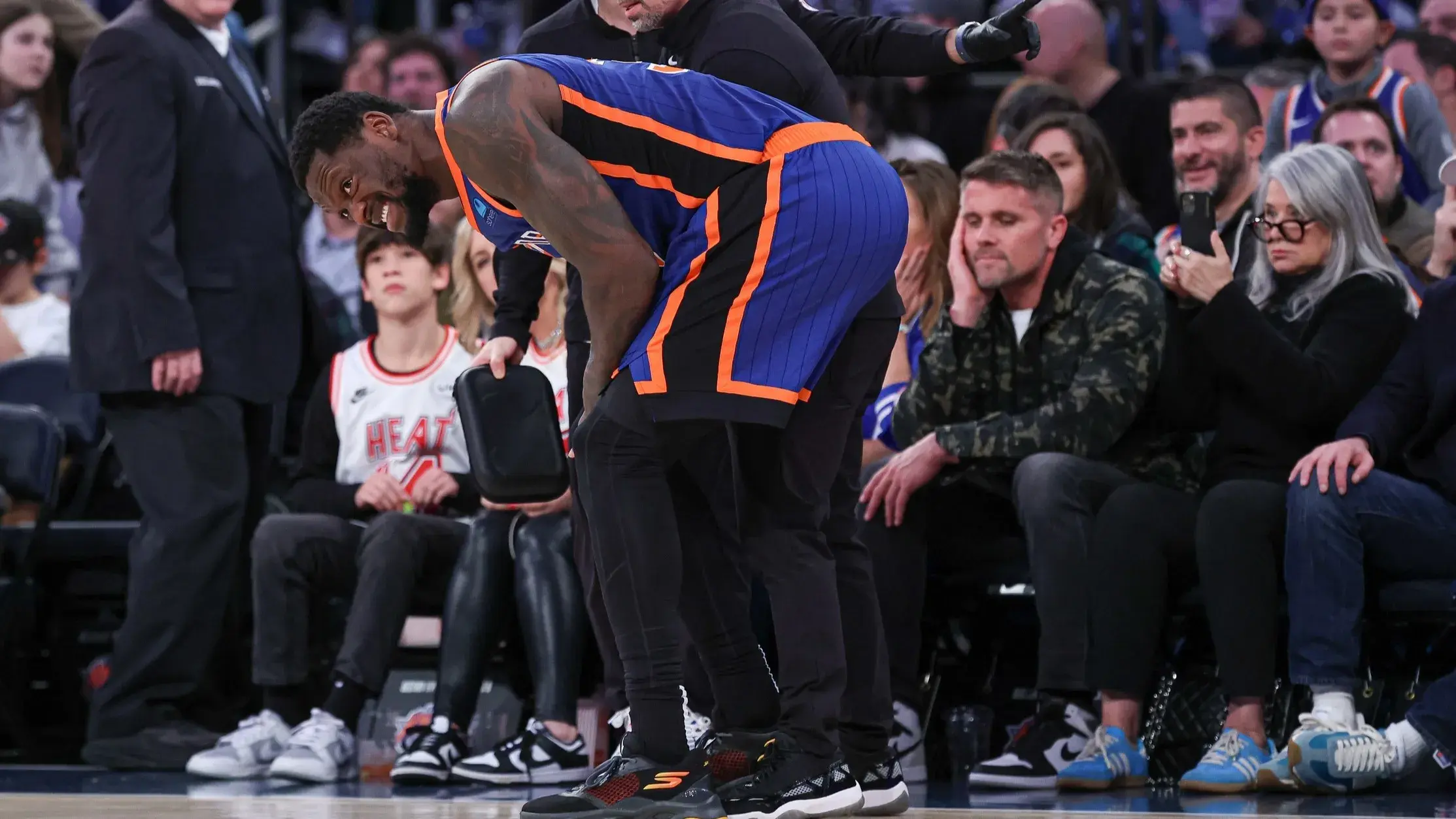 Jan 27, 2024; New York, New York, USA; New York Knicks forward Julius Randle (30) is helped by medical staff after an injury during the second half against the Miami Heat at Madison Square Garden. / Vincent Carchietta-USA TODAY Sports