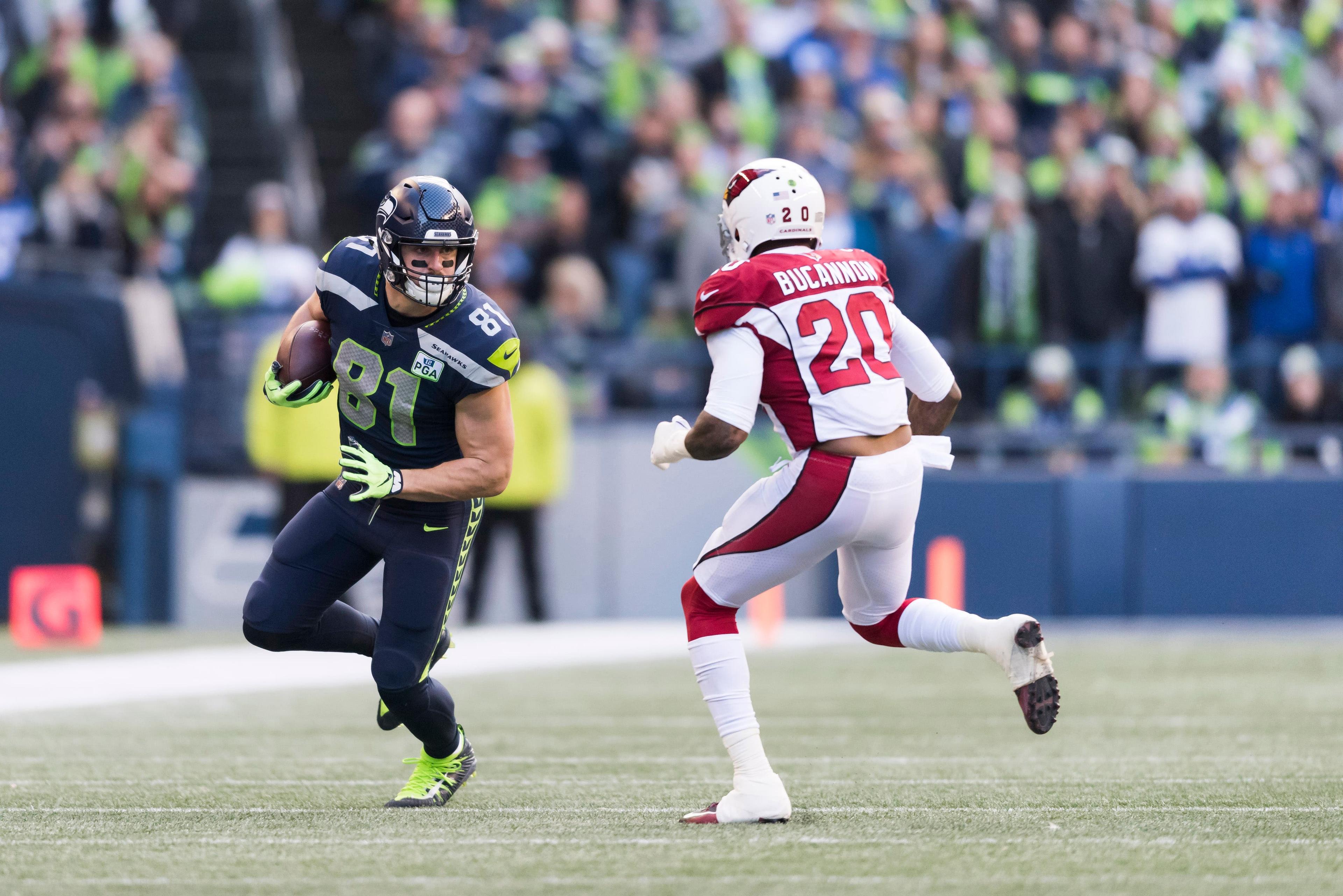 Dec 30, 2018; Seattle, WA, USA; Seattle Seahawks tight end Nick Vannett (81) carries the ball after a catch while being defended by Arizona Cardinals outside linebacker Deone Bucannon (20) during the first half at CenturyLink Field. Mandatory Credit: Steven Bisig-USA TODAY Sports / Steven Bisig