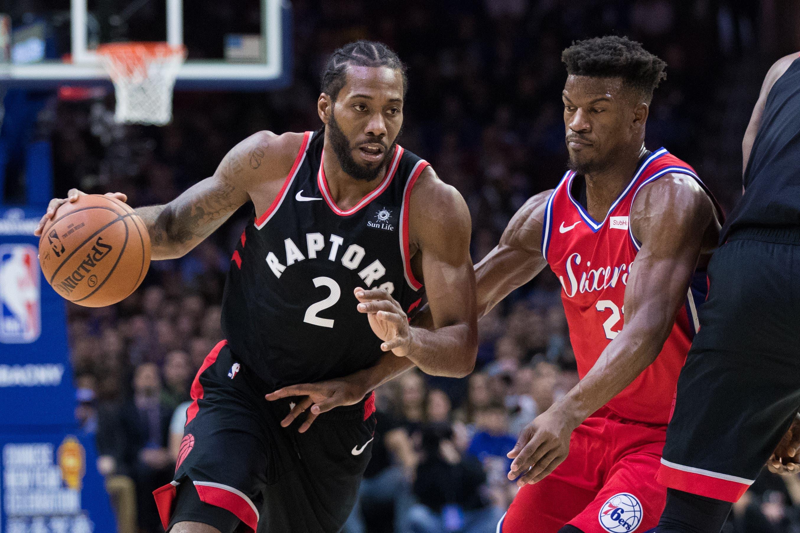 Toronto Raptors forward Kawhi Leonard drives against Philadelphia 76ers guard Jimmy Butler during the first quarter at Wells Fargo Center. / Bill Streicher/USA TODAY Sports