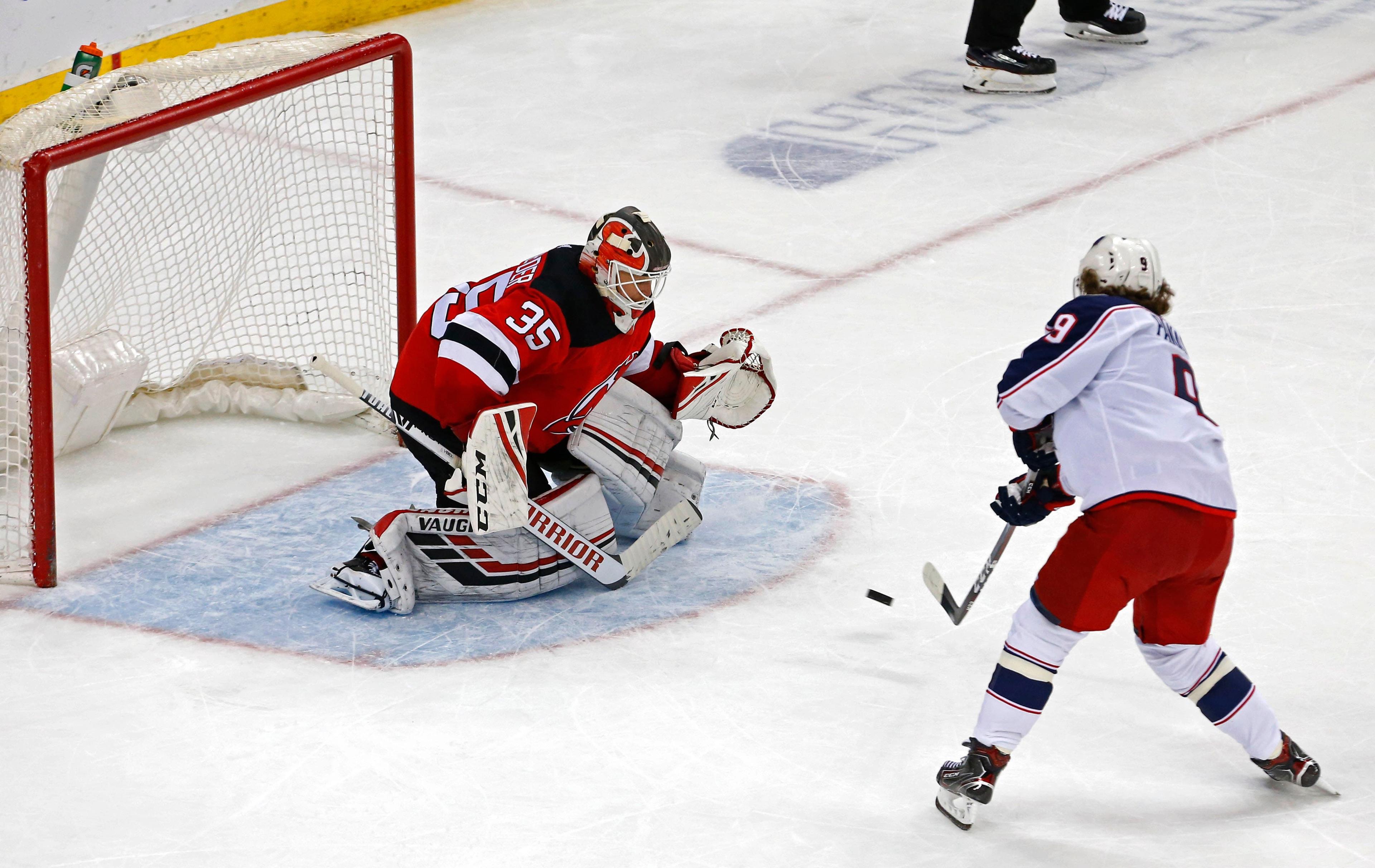 Mar 5, 2019; Newark, NJ, USA; Columbus Blue Jackets left wing Artemi Panarin (9) scores the game winning goal against New Jersey Devils goaltender Cory Schneider (35) during shootout at Prudential Center. Mandatory Credit: Noah K. Murray-USA TODAY Sports / Noah K. Murray