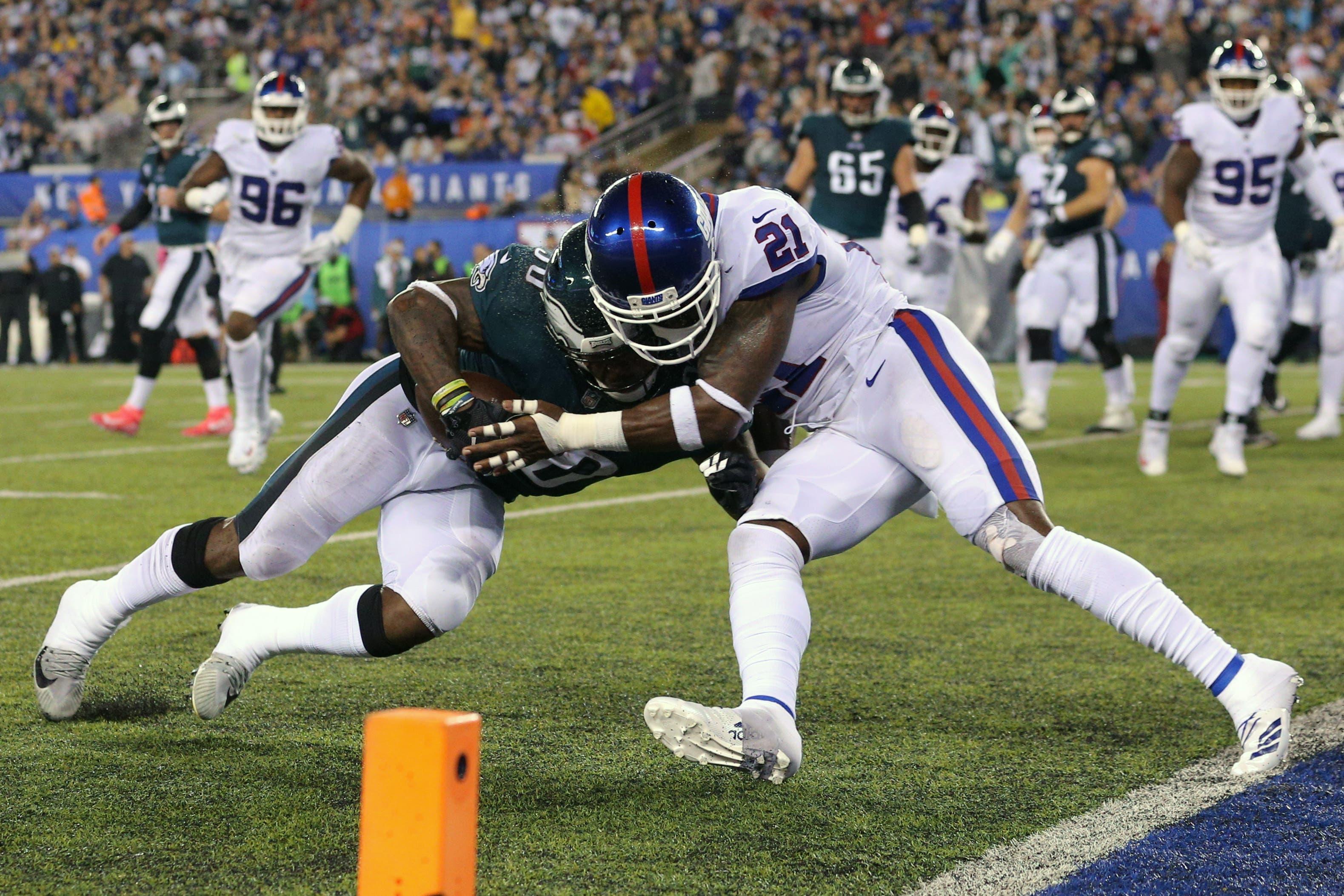 Philadelphia Eagles running back Corey Clement is hit by New York Giants safety Landon Collins during the first quarter at MetLife Stadium. / Brad Penner/USA TODAY Sports