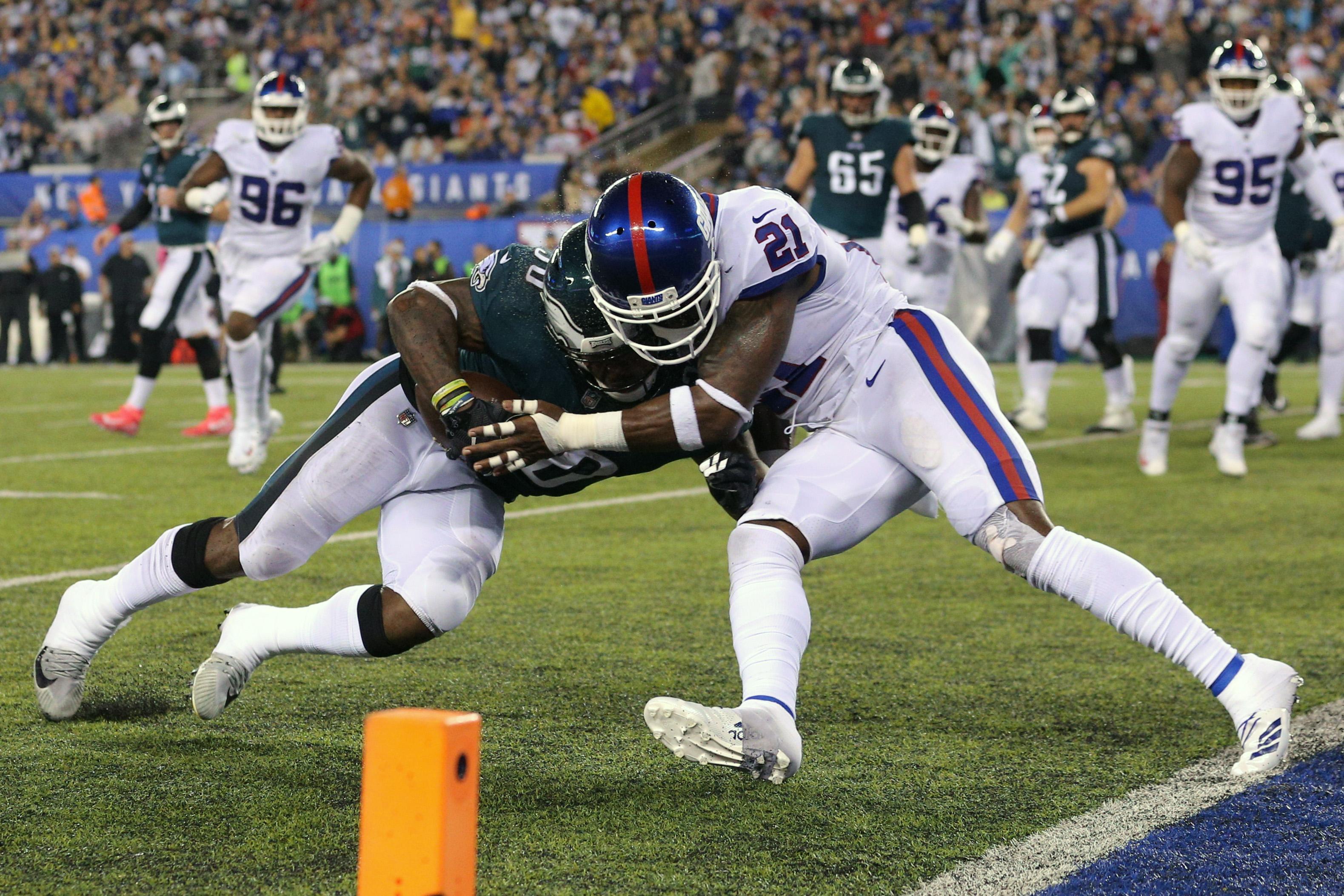 Philadelphia Eagles running back Corey Clement is hit by New York Giants safety Landon Collins during the first quarter at MetLife Stadium.