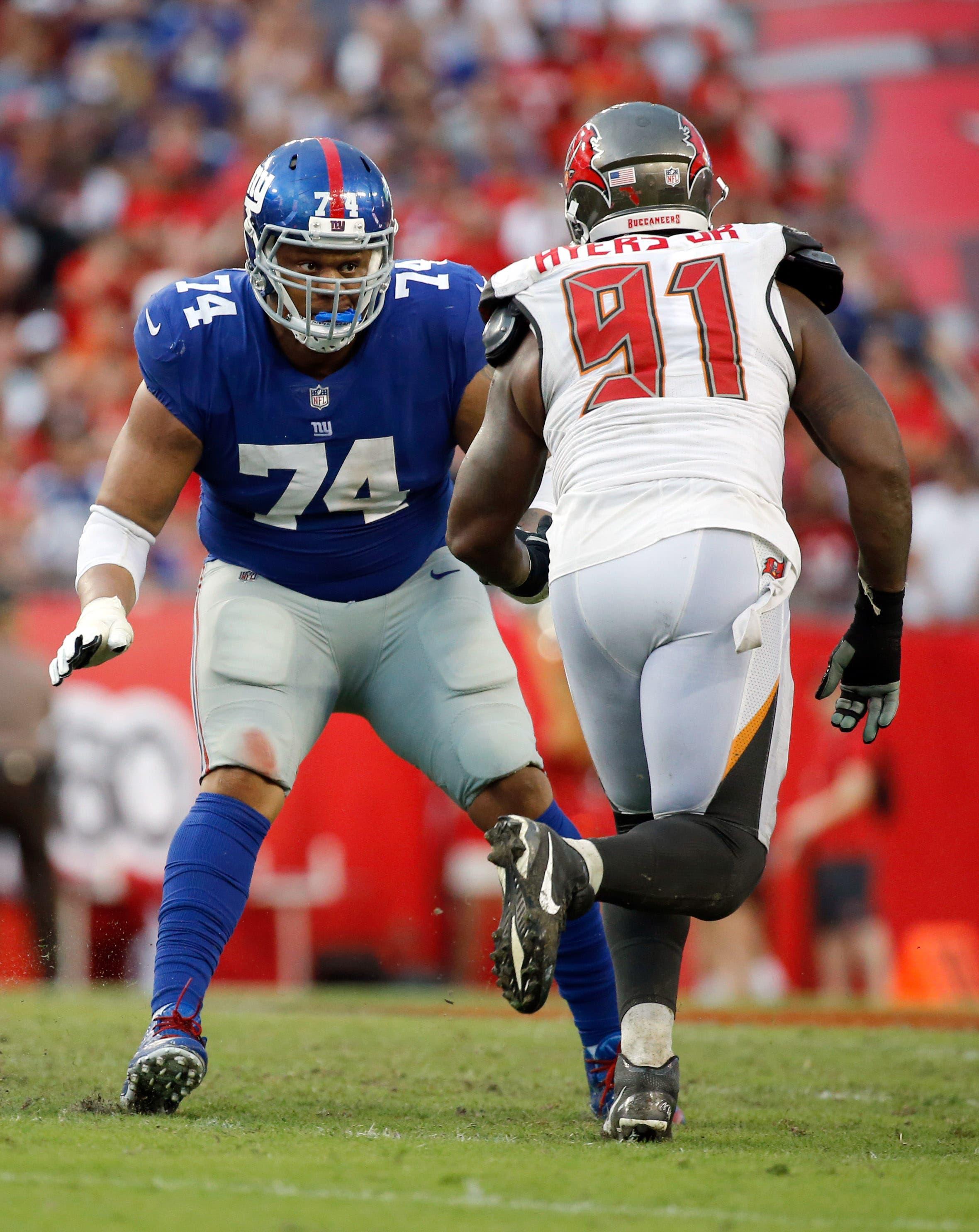 New York Giants offensive tackle Ereck Flowers blocks as Tampa Bay Buccaneers defensive end Robert Ayers rushes during the second half at Raymond James Stadium. / Kim Klement/USA TODAY Sports