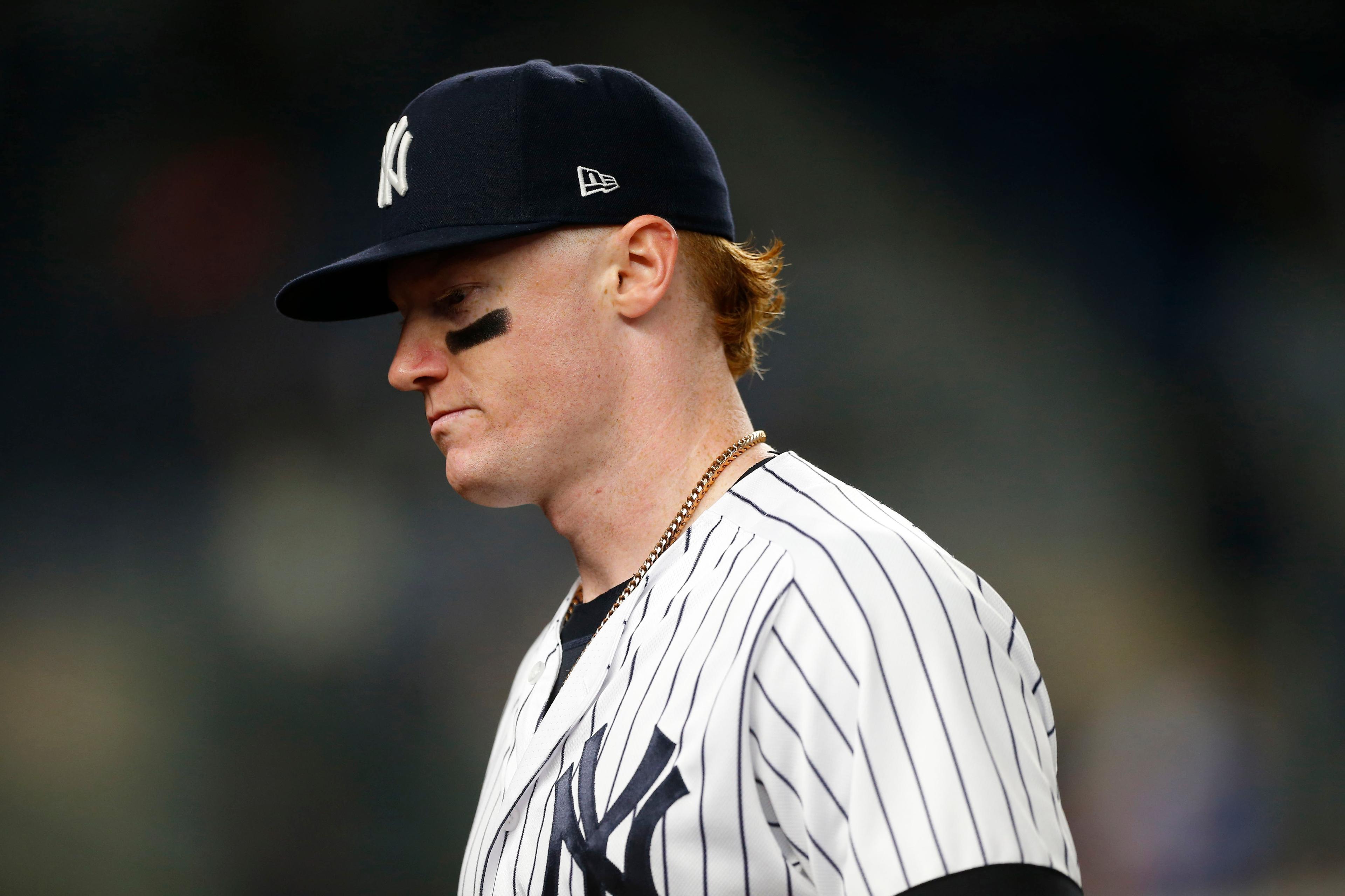 New York Yankees left fielder Clint Frazier walks to the dugout between innings against the Kansas City Royals at Yankee Stadium.