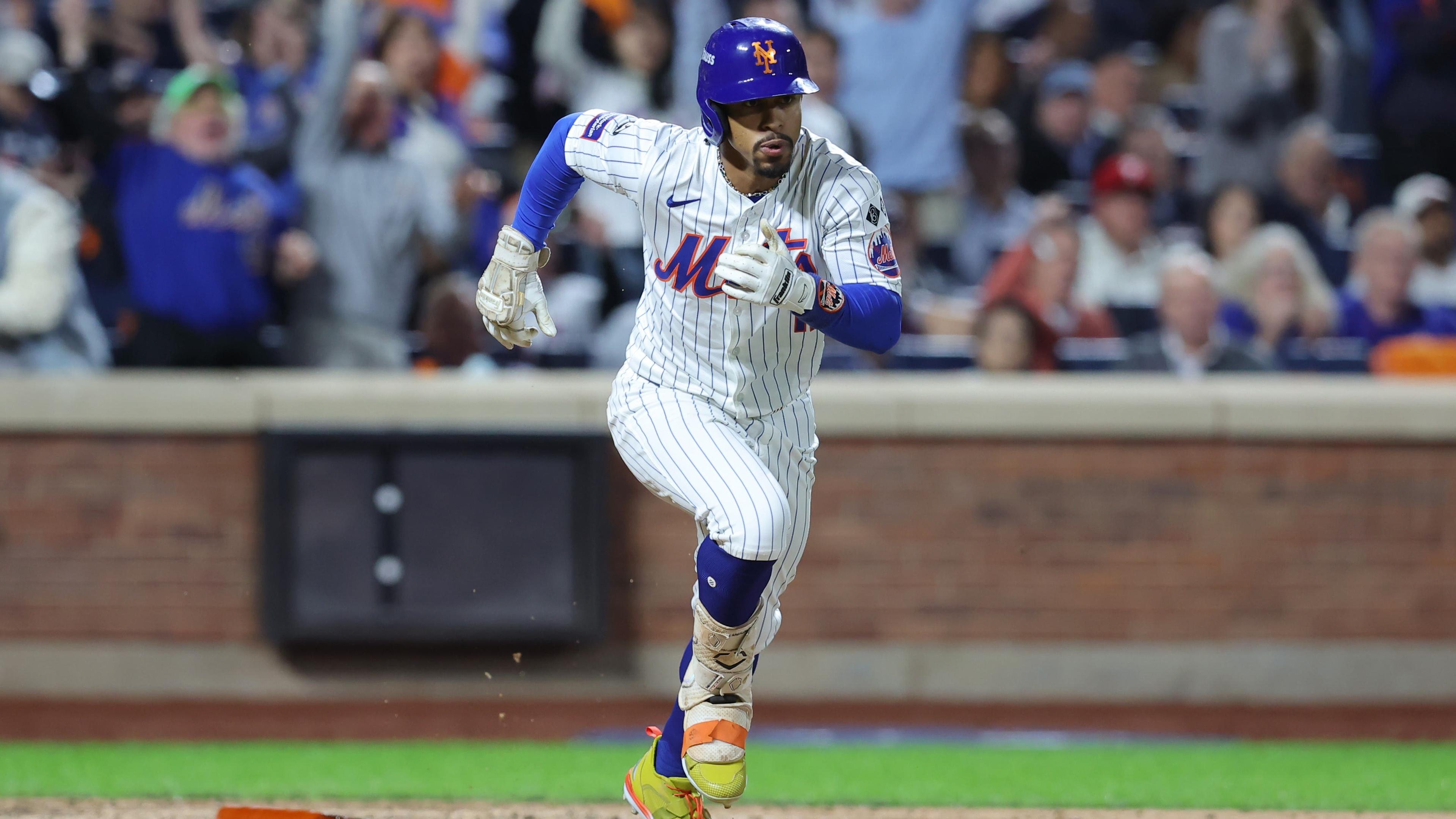 Oct 8, 2024; New York City, New York, USA; New York Mets shortstop Francisco Lindor (12) runs after hitting an RBI double against the Philadelphia Phillies in the eighth inning during game three of the NLDS for the 2024 MLB Playoffs at Citi Field. 