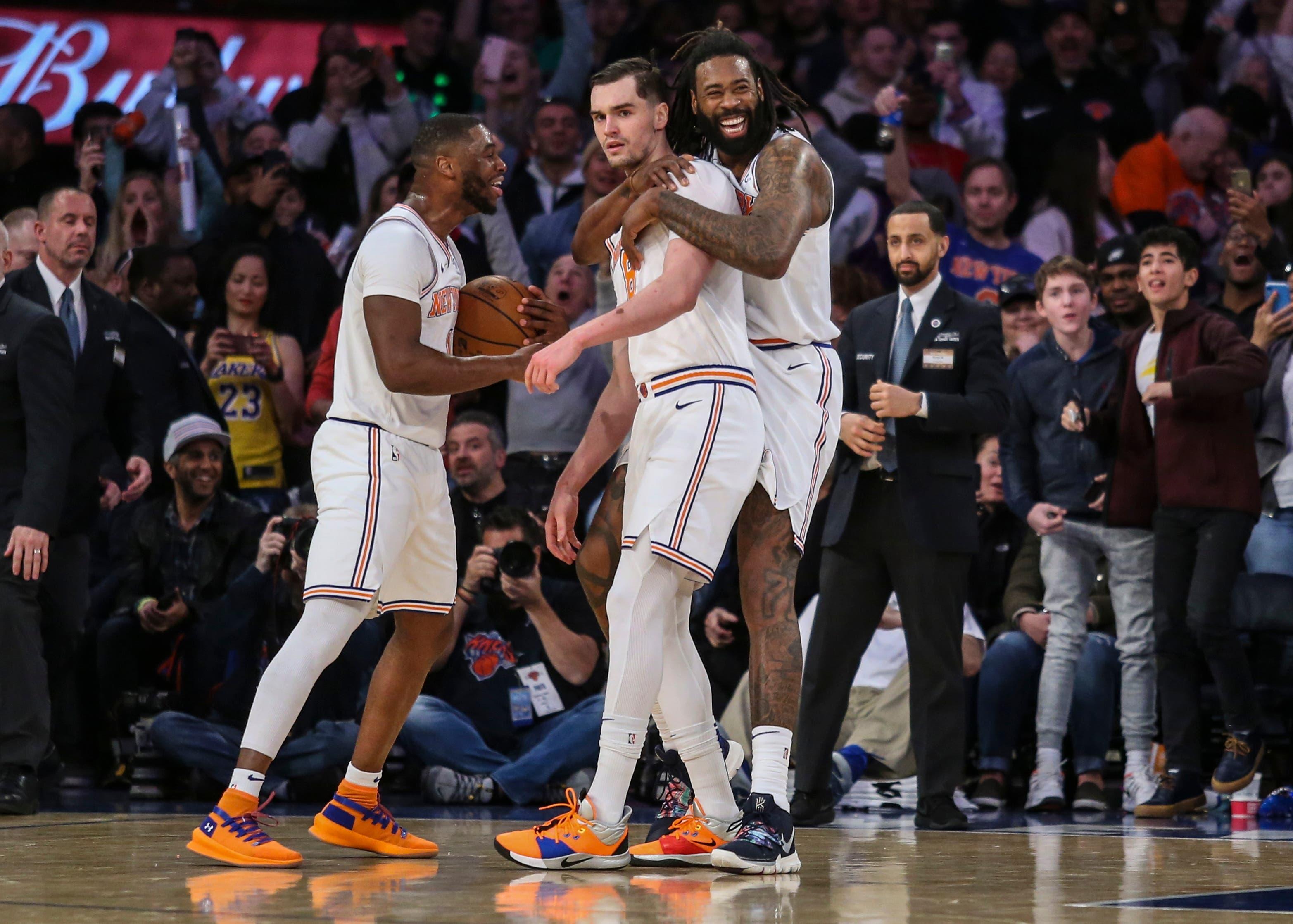 New York Knicks guard Emmanuel Mudiay, forward Mario Hezonja and center DeAndre Jordan celebrate the Knicks' 124-123 victory over the Los Angeles Lakers at Madison Square Garden. / Wendell Cruz/USA TODAY Sports