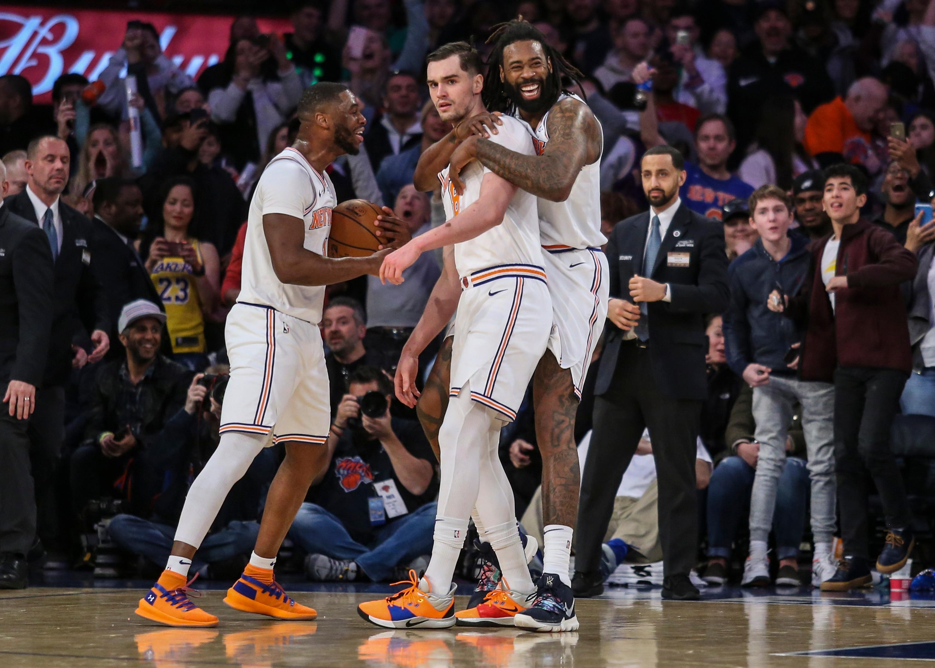 New York Knicks guard Emmanuel Mudiay, forward Mario Hezonja and center DeAndre Jordan celebrate the Knicks' 124-123 victory over the Los Angeles Lakers at Madison Square Garden.