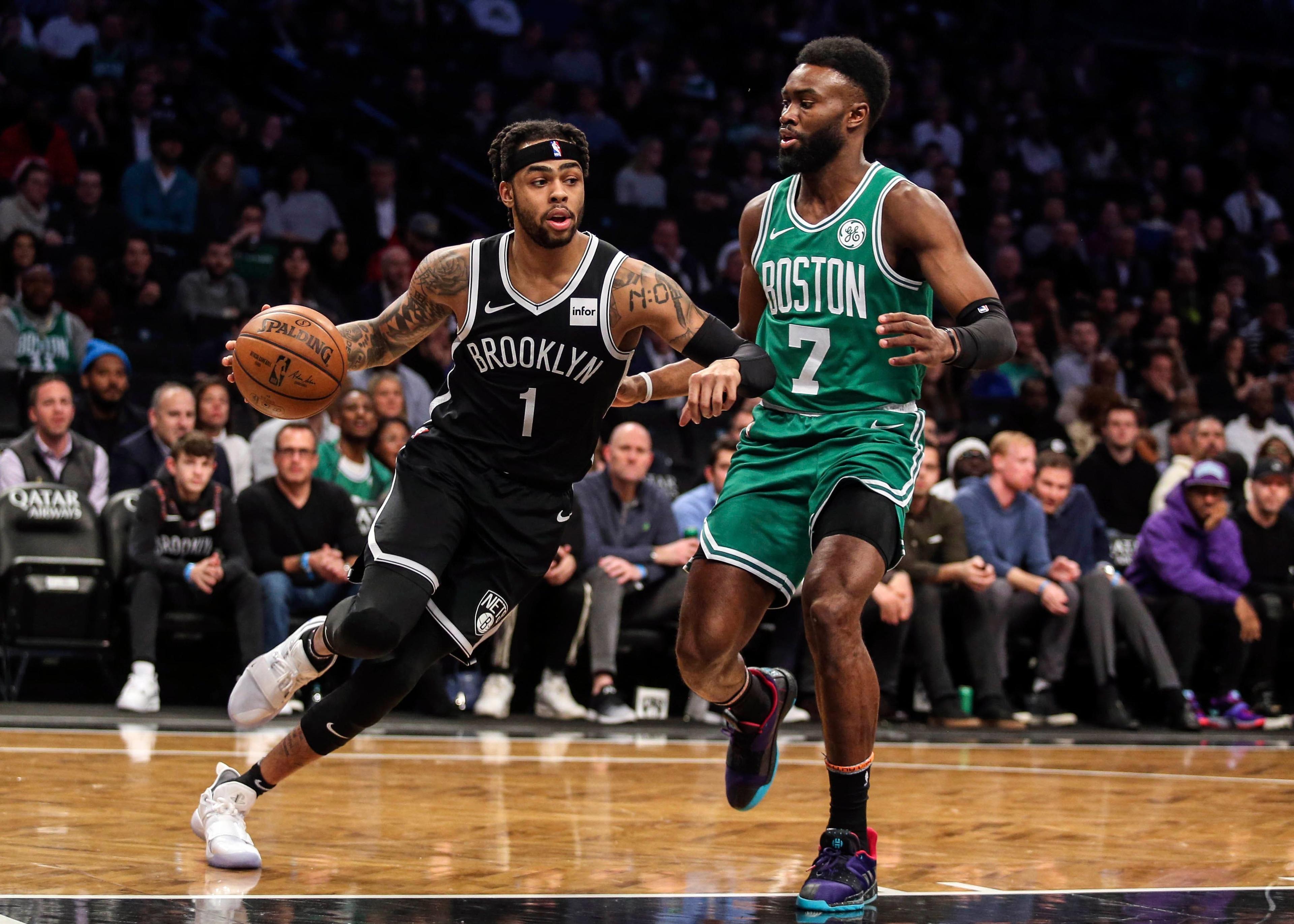 Brooklyn Nets guard D'Angelo Russell drives past Boston Celtics forward Jaylen Brown in the first quarter at Barclays Center. / Wendell Cruz/USA TODAY Sports