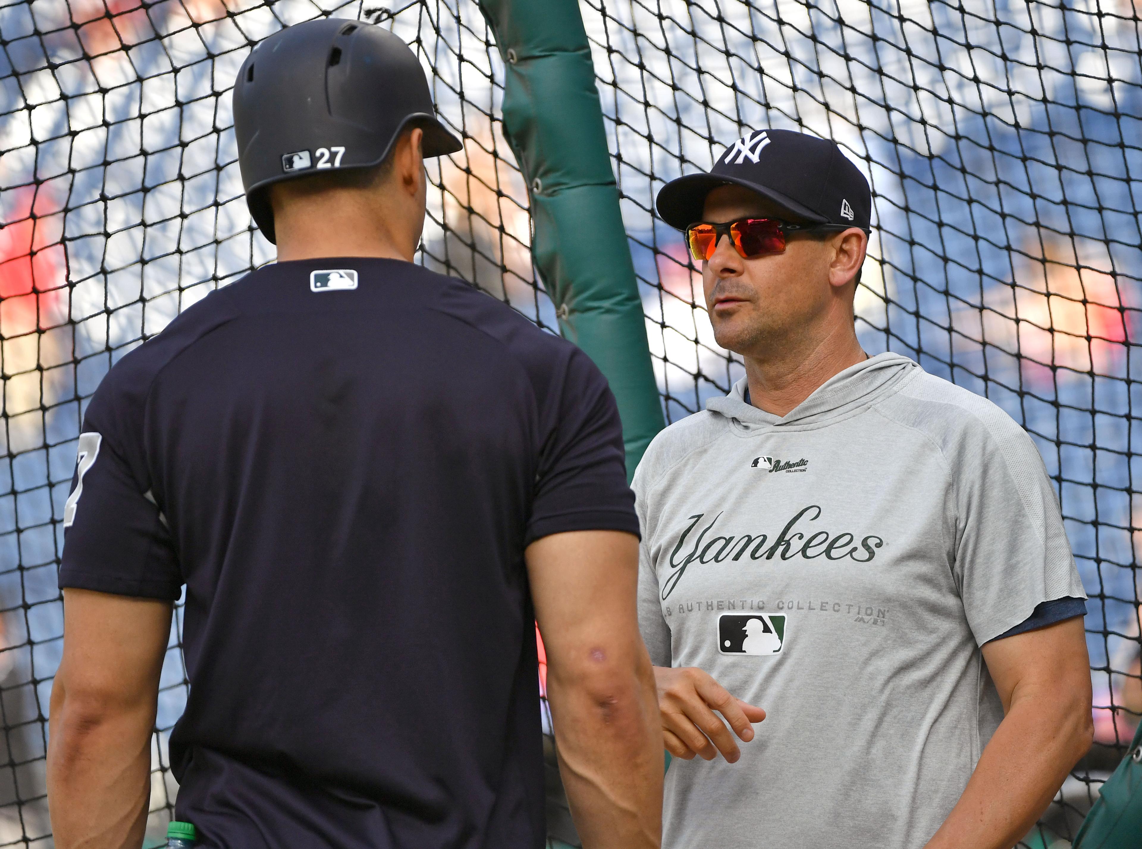 Jun 25, 2018; Philadelphia, PA, USA; New York Yankees manager Aaron Boone (right) talks with left fielder Giancarlo Stanton (left) during batting practice before a game against the Philadelphia Phillies at Citizens Bank Park. Mandatory Credit: Eric Hartline-USA TODAY Sports