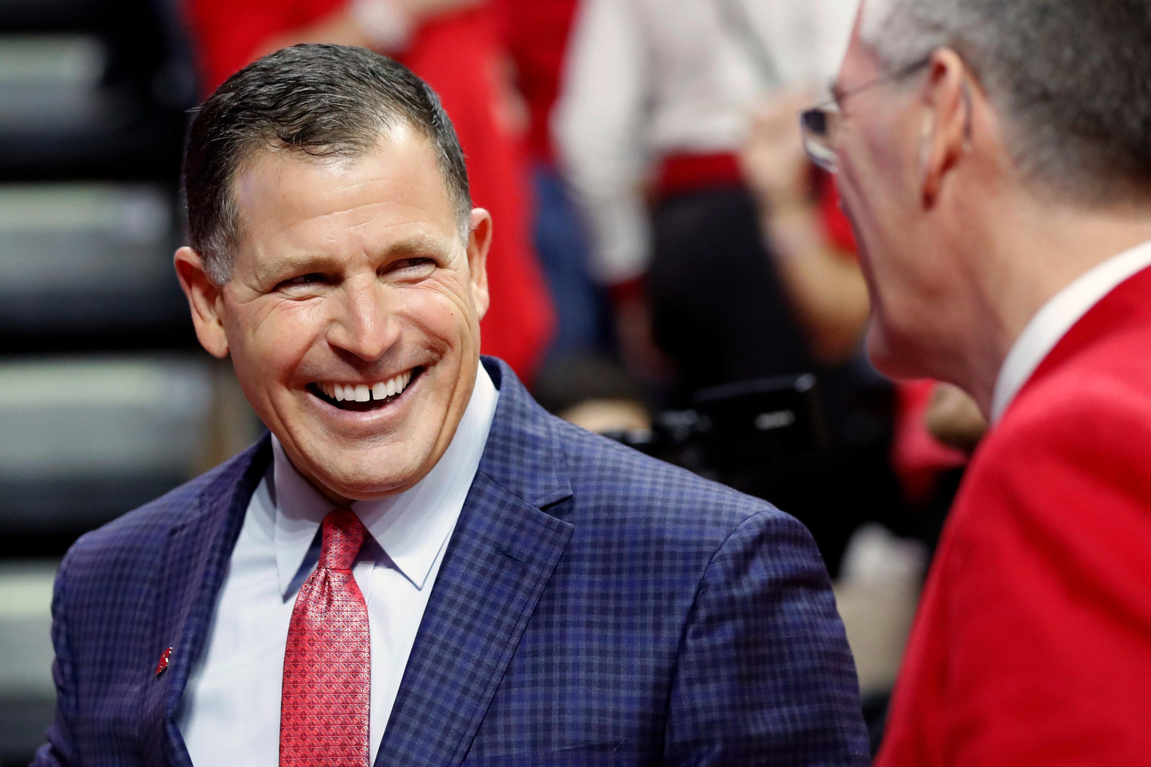 Rutgers head football coach Greg Schiano smiles as he enters the Rutgers Athletic Center (RAC) before the start of an NCAA college basketball game against Seton Hall, Saturday, Dec. 14, 2019, in Piscataway, N.J. Schiano returned to Rutgers to rebuild the schoolâ€™s football program. (AP Photo/Kathy Willens) / Kathy Willens/AP