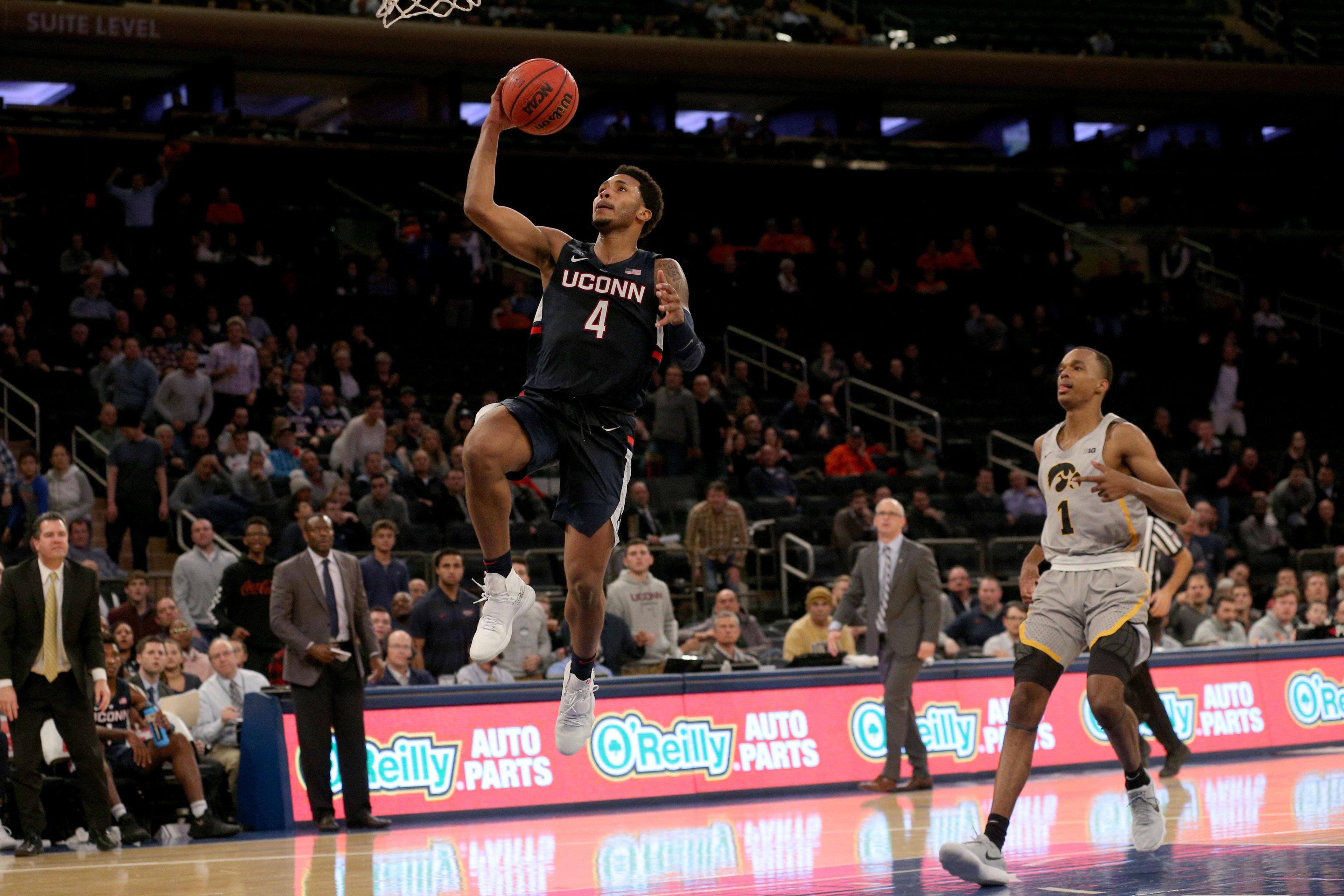 Nov 16, 2018; New York, NY, USA; Connecticut Huskies guard Jalen Adams (4) drives to the basket against Iowa Hawkeyes guard Maishe Dailey (1) during the second half at Madison Square Garden. Mandatory Credit: Brad Penner-USA TODAY Sports / Brad Penner