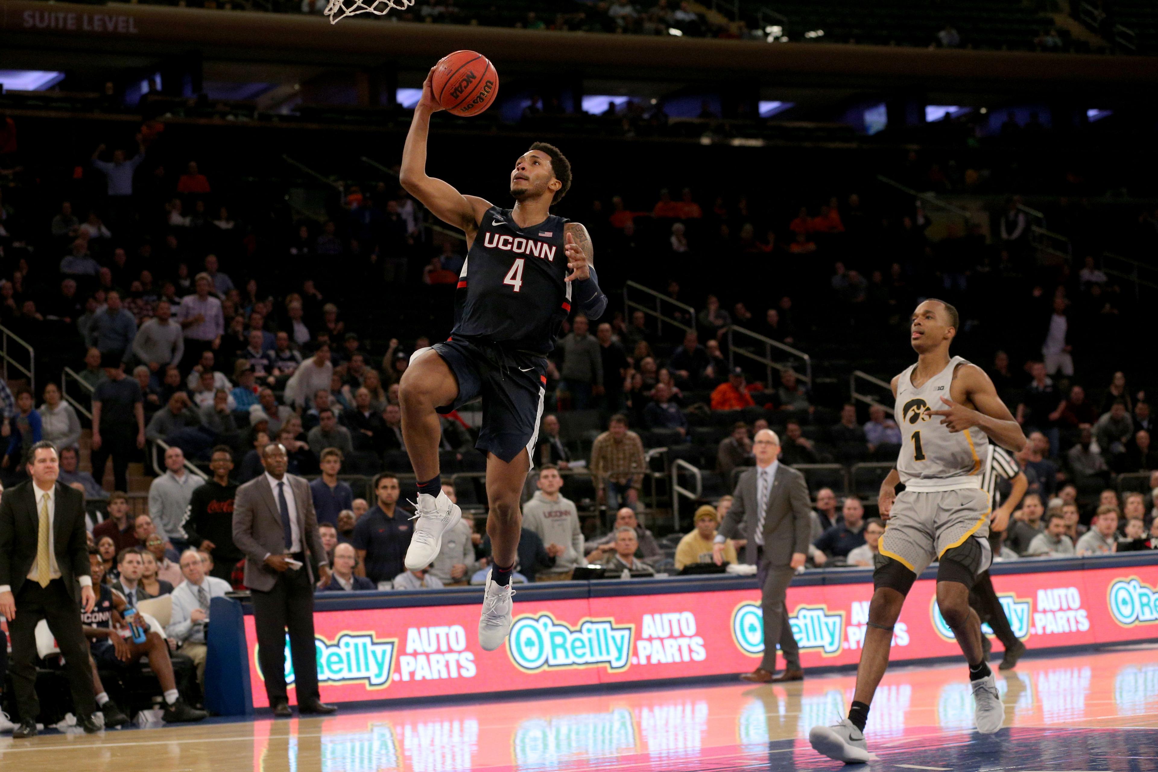 Nov 16, 2018; New York, NY, USA; Connecticut Huskies guard Jalen Adams (4) drives to the basket against Iowa Hawkeyes guard Maishe Dailey (1) during the second half at Madison Square Garden. Mandatory Credit: Brad Penner-USA TODAY Sports