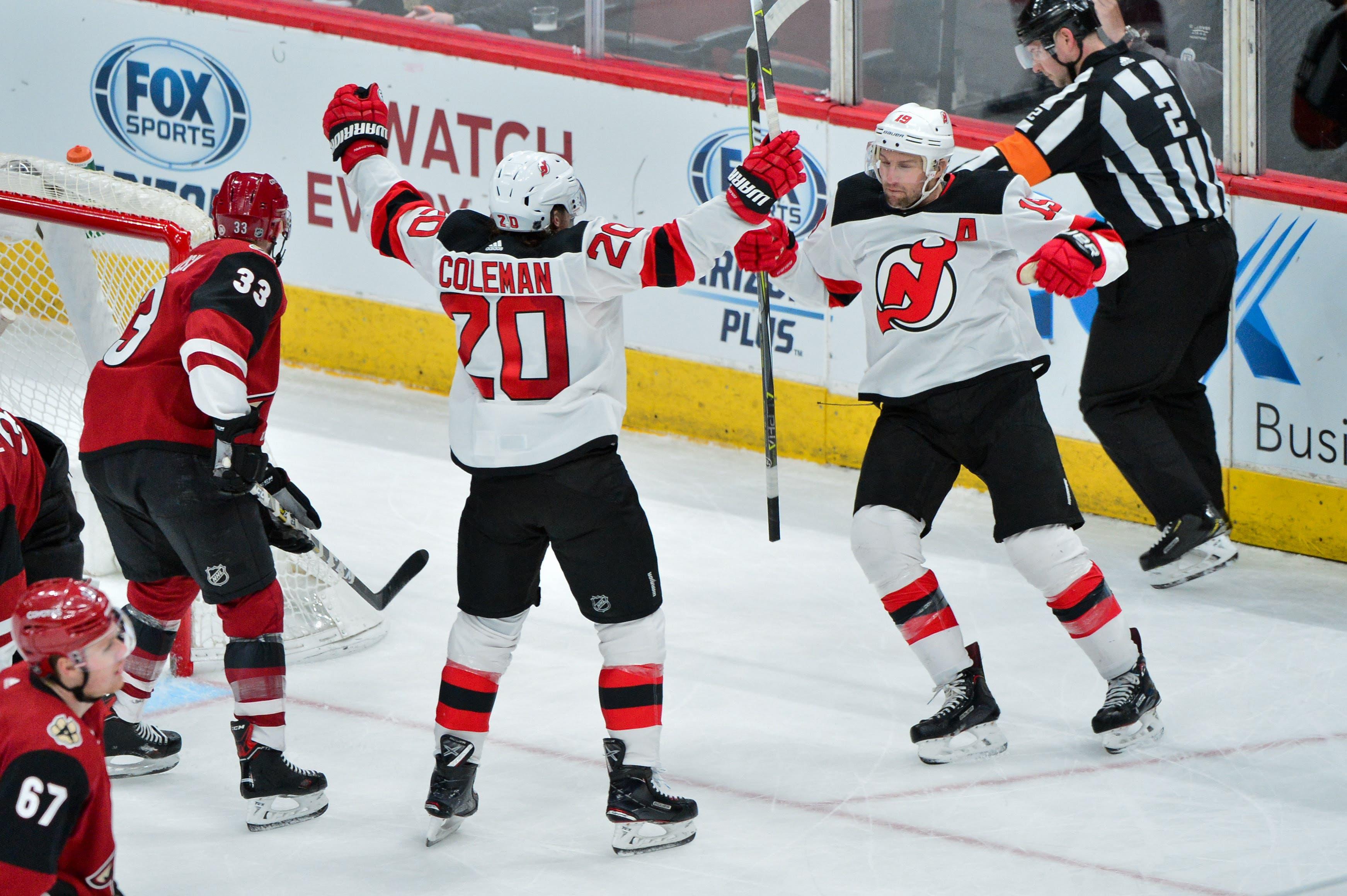 Jan 4, 2019; Glendale, AZ, USA; New Jersey Devils center Blake Coleman (20) celebrates with New Jersey Devils center Travis Zajac (19) after scoring a goal in the second period against the Arizona Coyotes at Gila River Arena. Mandatory Credit: Matt Kartozian-USA TODAY Sports / Matt Kartozian