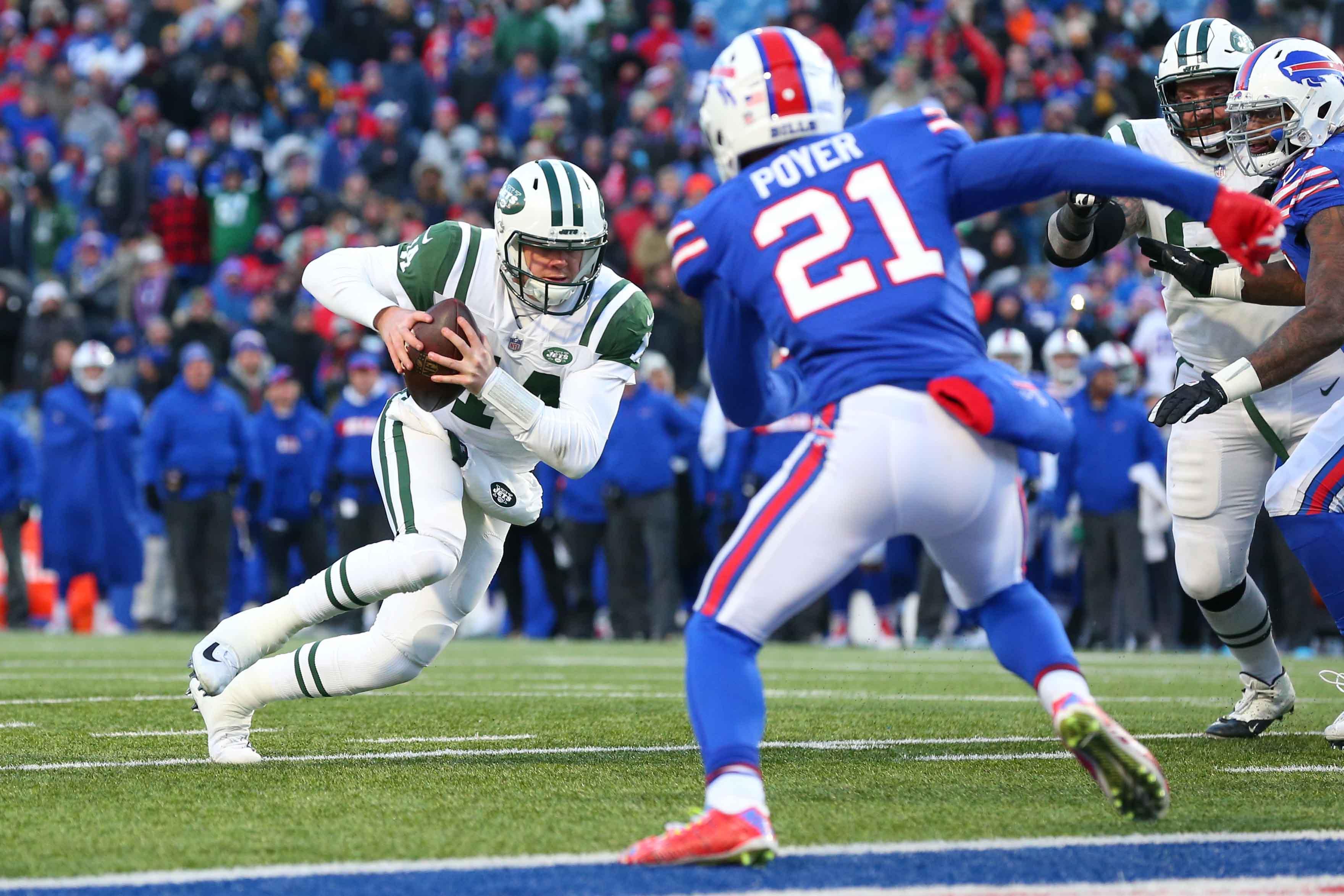 New York Jets quarterback Sam Darnold runs with the ball as Buffalo Bills free safety Jordan Poyer defends during the fourth quarter at New Era Field.