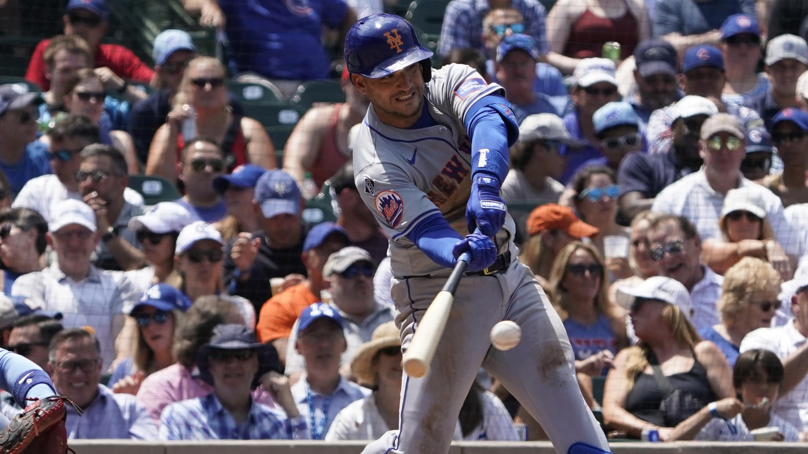 New York Mets second baseman Jose Iglesias (11) hits a single against the New York Mets during the third inning at Wrigley Field.