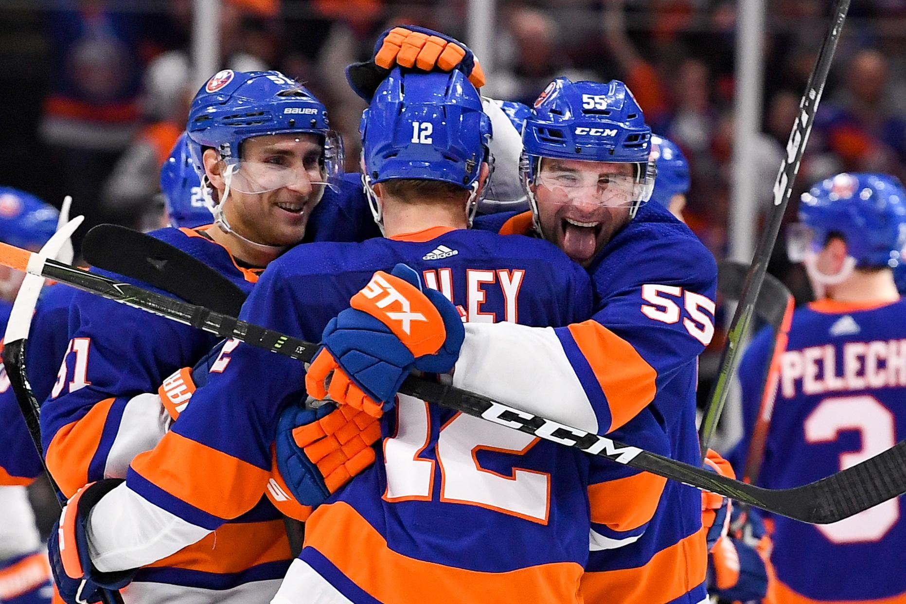 Apr 10, 2019; Brooklyn, NY, USA; New York Islanders defenseman Johnny Boychuk (55) celebrates after the game with right wing Josh Bailey (12) and center Valtteri Filppula (51) in the gam against the Pittsburgh Penguins in game one of the first round of the 2019 Stanley Cup Playoffs at Barclays Center. Mandatory Credit: Dennis Schneidler-USA TODAY Sports 