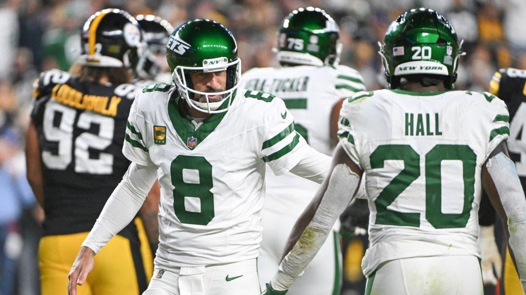 Oct 20, 2024; Pittsburgh, Pennsylvania, USA; New York Jets running back Breece Hall (20) and quarterback Aaron Rodgers (8) celebrate a touchdown against the Pittsburgh Steelers during the first quarter at Acrisure Stadium.