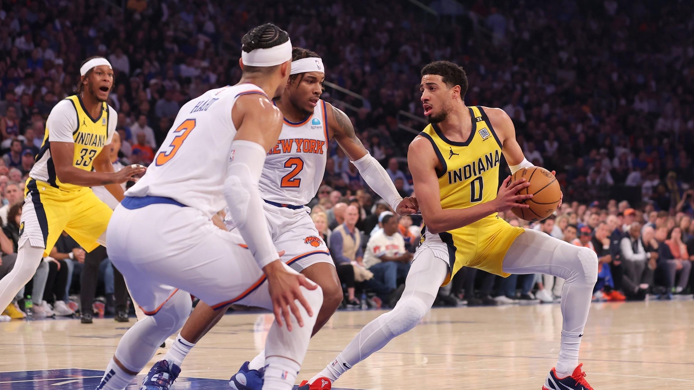 Indiana Pacers guard Tyrese Haliburton (0) handles the ball against New York Knicks guards Miles McBride (2) and Josh Hart (3) during the first quarter of game seven of the second round of the 2024 NBA playoffs at Madison Square Garden.