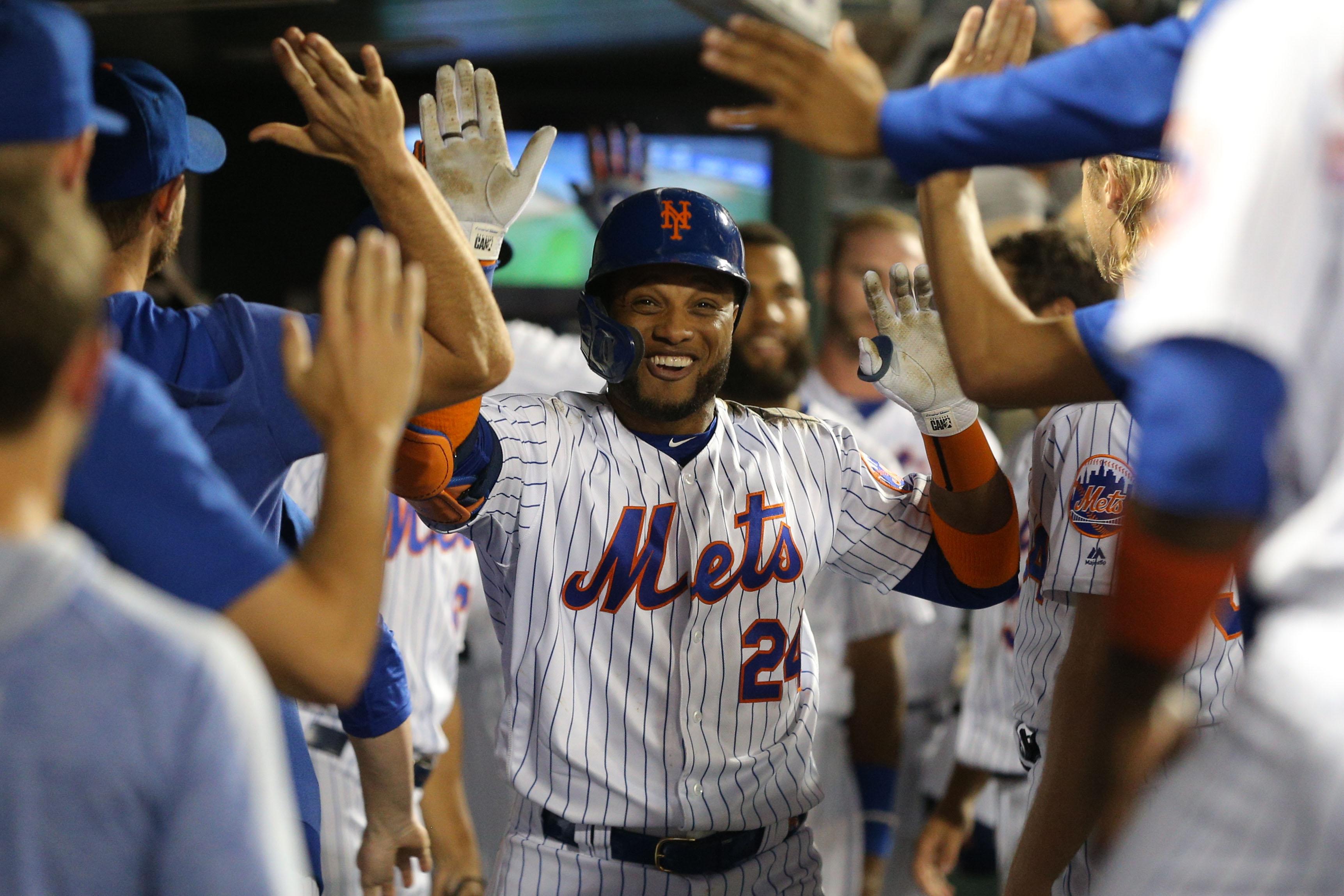 Jul 23, 2019; New York City, NY, USA; New York Mets second baseman Robinson Cano (24) celebrates his two run home run against the San Diego Padres in the dugout with teammates during the sixth inning at Citi Field. Mandatory Credit: Brad Penner-USA TODAY Sports