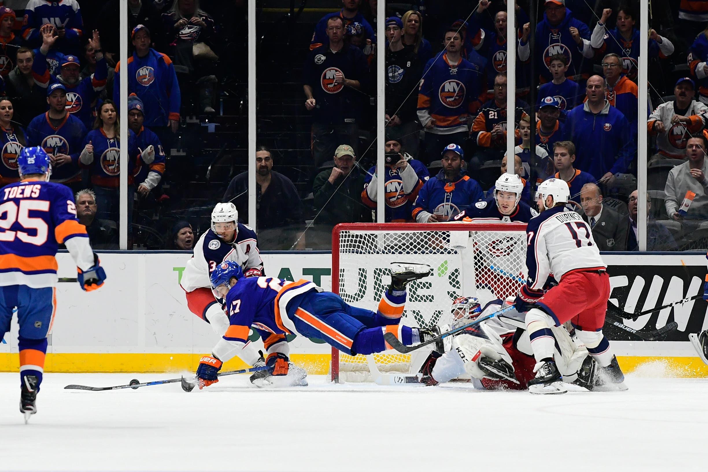 New York Islanders left wing Anders Lee falls onto the ice while attempting a shot on goal against the Columbus Blue Jackets during the first period at Nassau Veterans Memorial Coliseum. / Catalina Fragoso/USA TODAY Sports