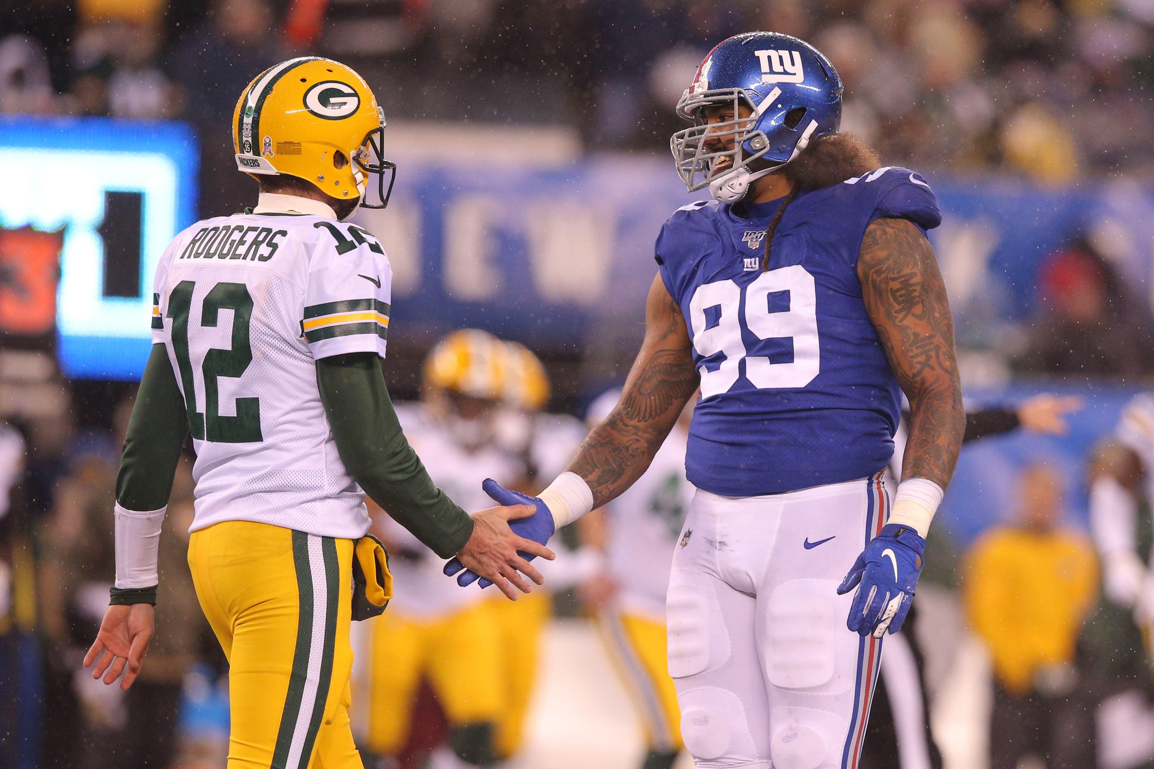 Dec 1, 2019; East Rutherford, NJ, USA; Green Bay Packers quarterback Aaron Rodgers (12) and New York Giants defensive end Leonard Williams (99) shake hands after a play during the fourth quarter at MetLife Stadium. Mandatory Credit: Brad Penner-USA TODAY Sports / Brad Penner