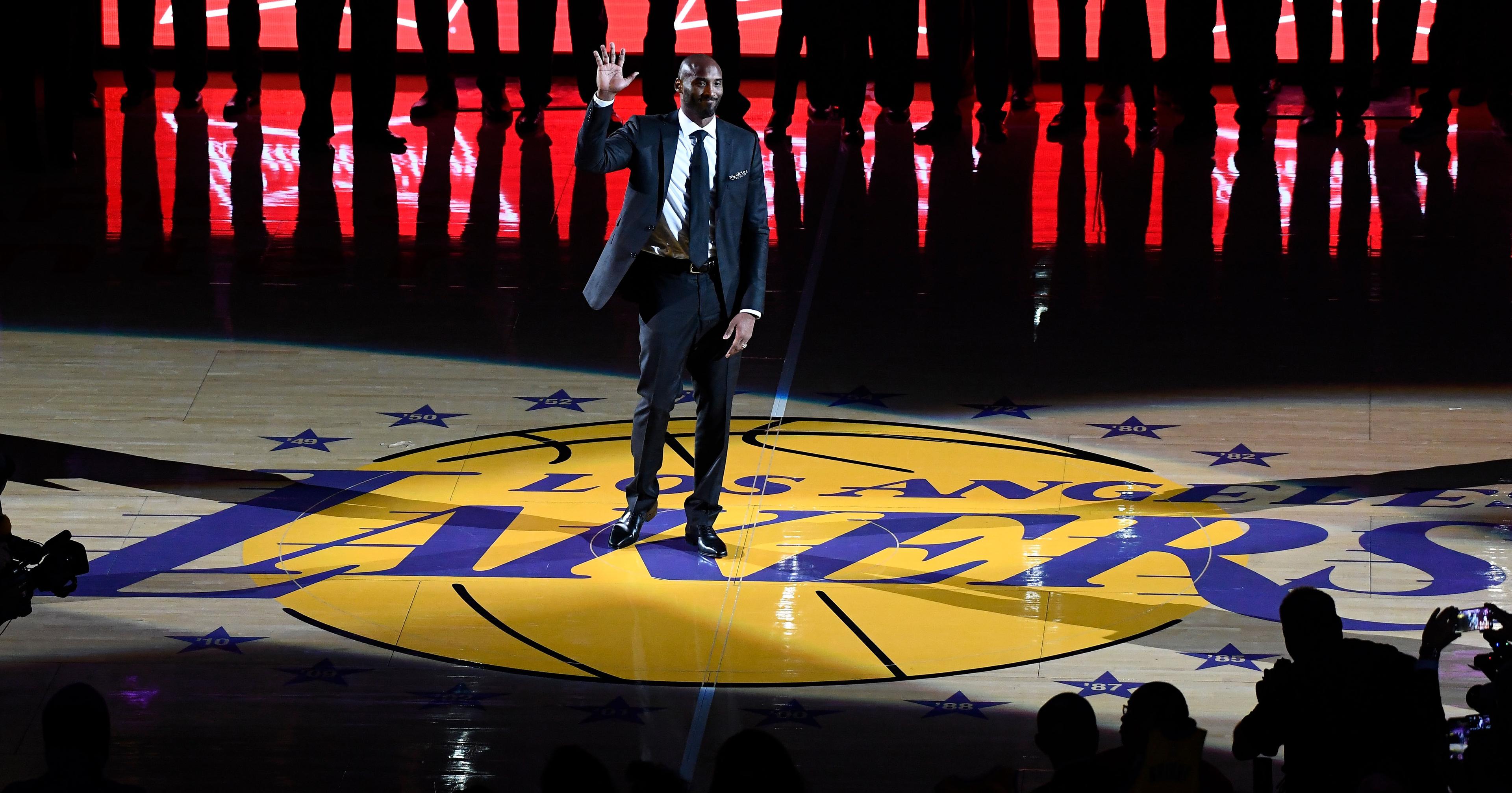 Dec 18, 2017; Los Angeles, CA, USA; Los Angeles Laker great Kobe Bryant waves to the crowd at the start of a ceremony at halftime to retire his two jersey numbers, 8 and 24 at Staples Center. Mandatory Credit: Robert Hanashiro-USA TODAY Sports