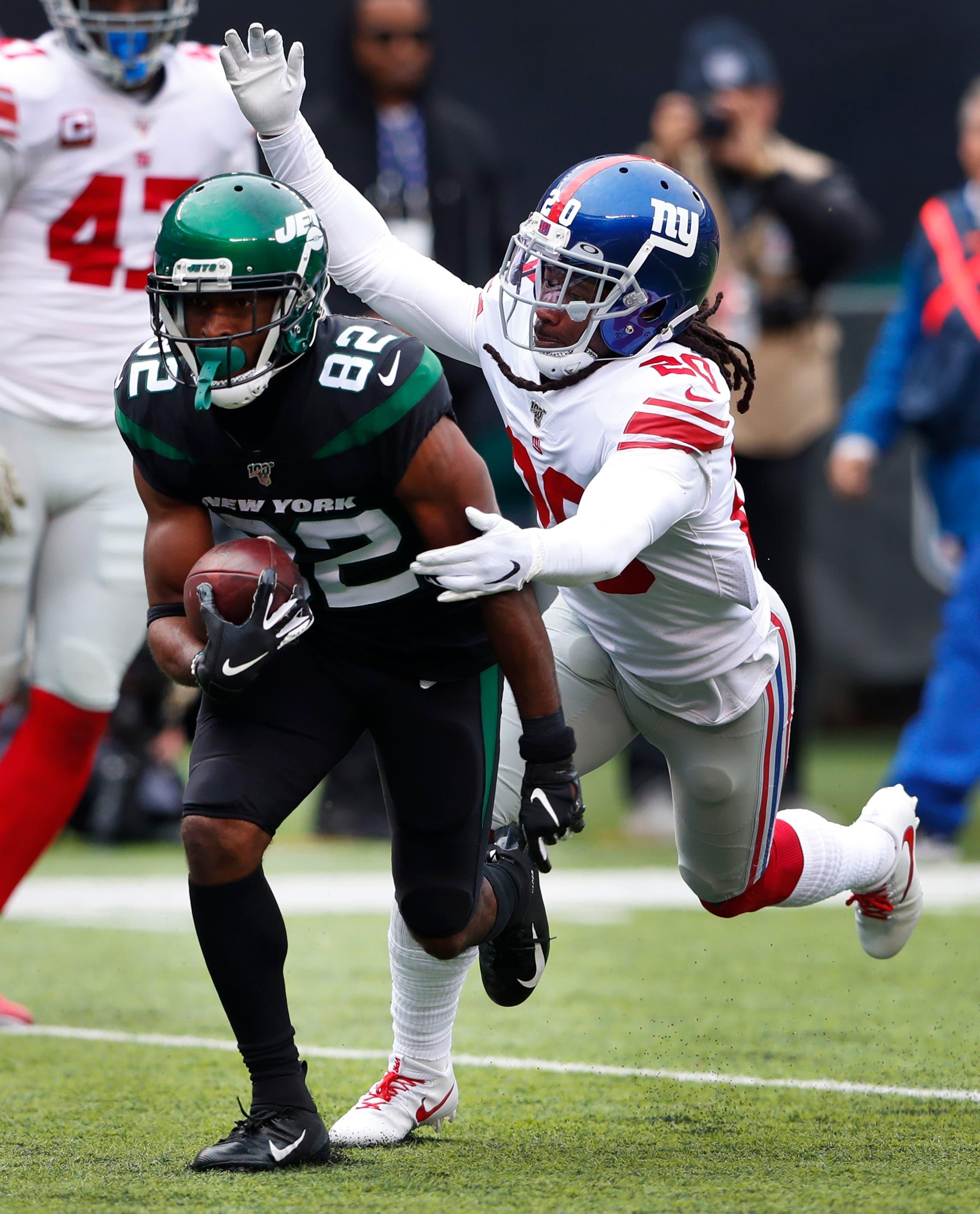 Nov 10, 2019; East Rutherford, NJ, USA; New York Jets wide receiver Jamison Crowder (82) rushes for a touchdown against New York Giants cornerback Janoris Jenkins (20) during the first quarter at MetLife Stadium. Mandatory Credit: Noah K. Murray-USA TODAY Sports / Noah K. Murray