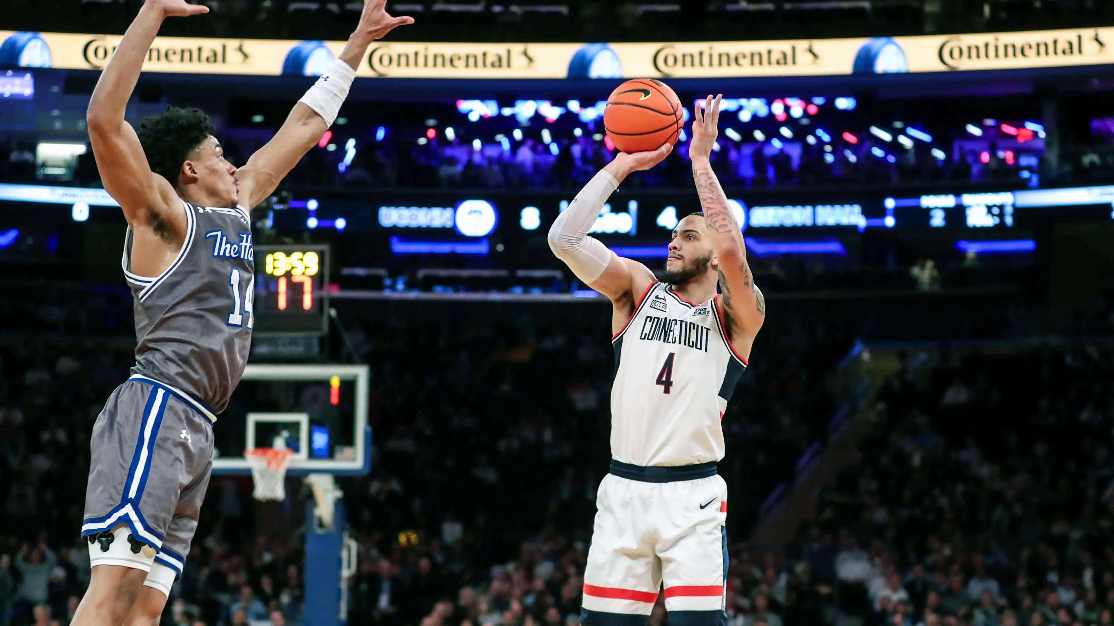 Mar 10, 2022; New York, NY, USA; Connecticut Huskies guard Tyrese Martin (4) shoots past Seton Hall Pirates guard Jared Rhoden (14) in the first half at the Big East Tournament at Madison Square Garden. / Wendell Cruz-USA TODAY Sports