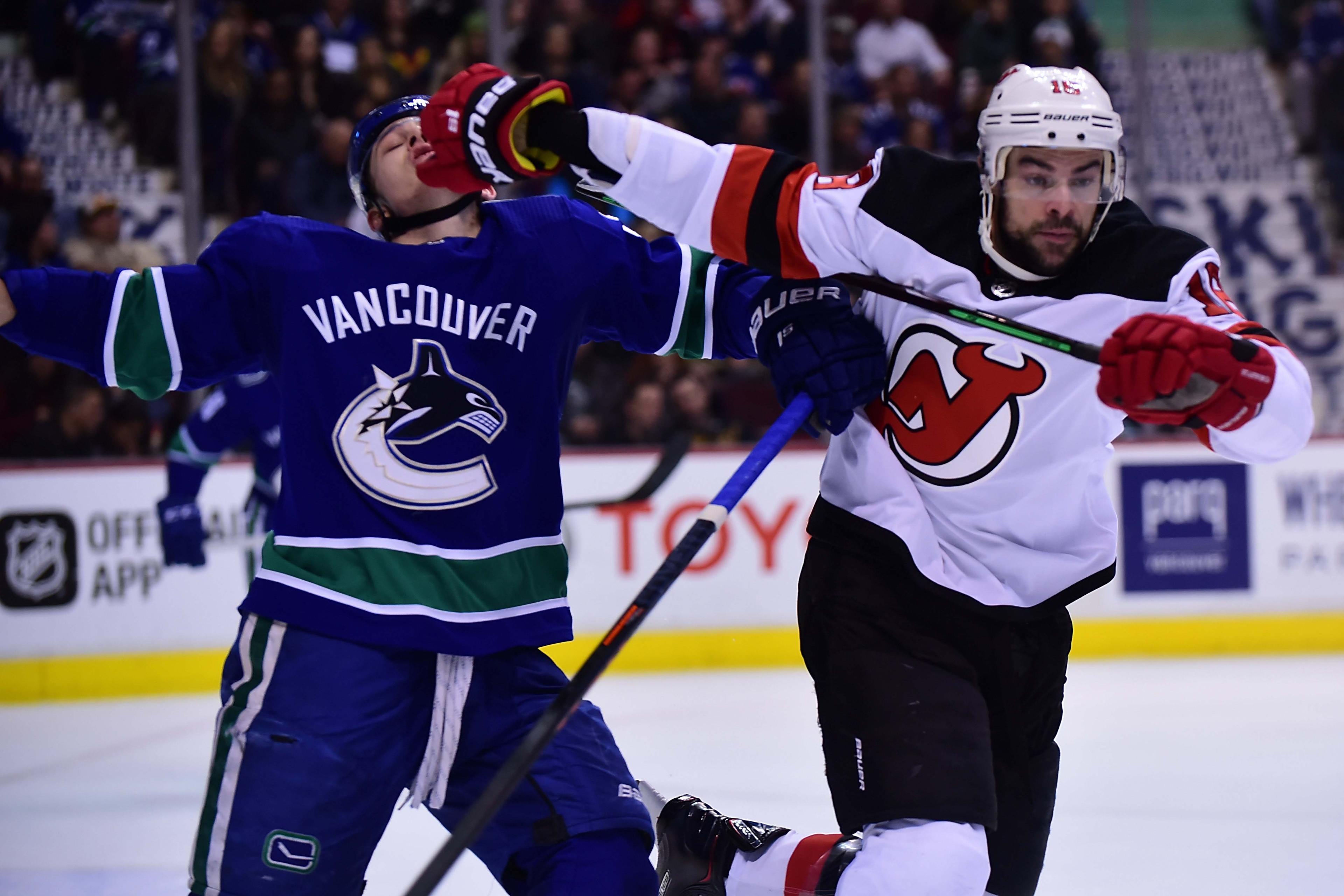 Mar 15, 2019; Vancouver, British Columbia, CAN; New Jersey Devils defenseman Steven Santini (16) defends against Vancouver Canucks defenseman Troy Stecher (51) during the second period at Rogers Arena. Mandatory Credit: Anne-Marie Sorvin-USA TODAY Sports