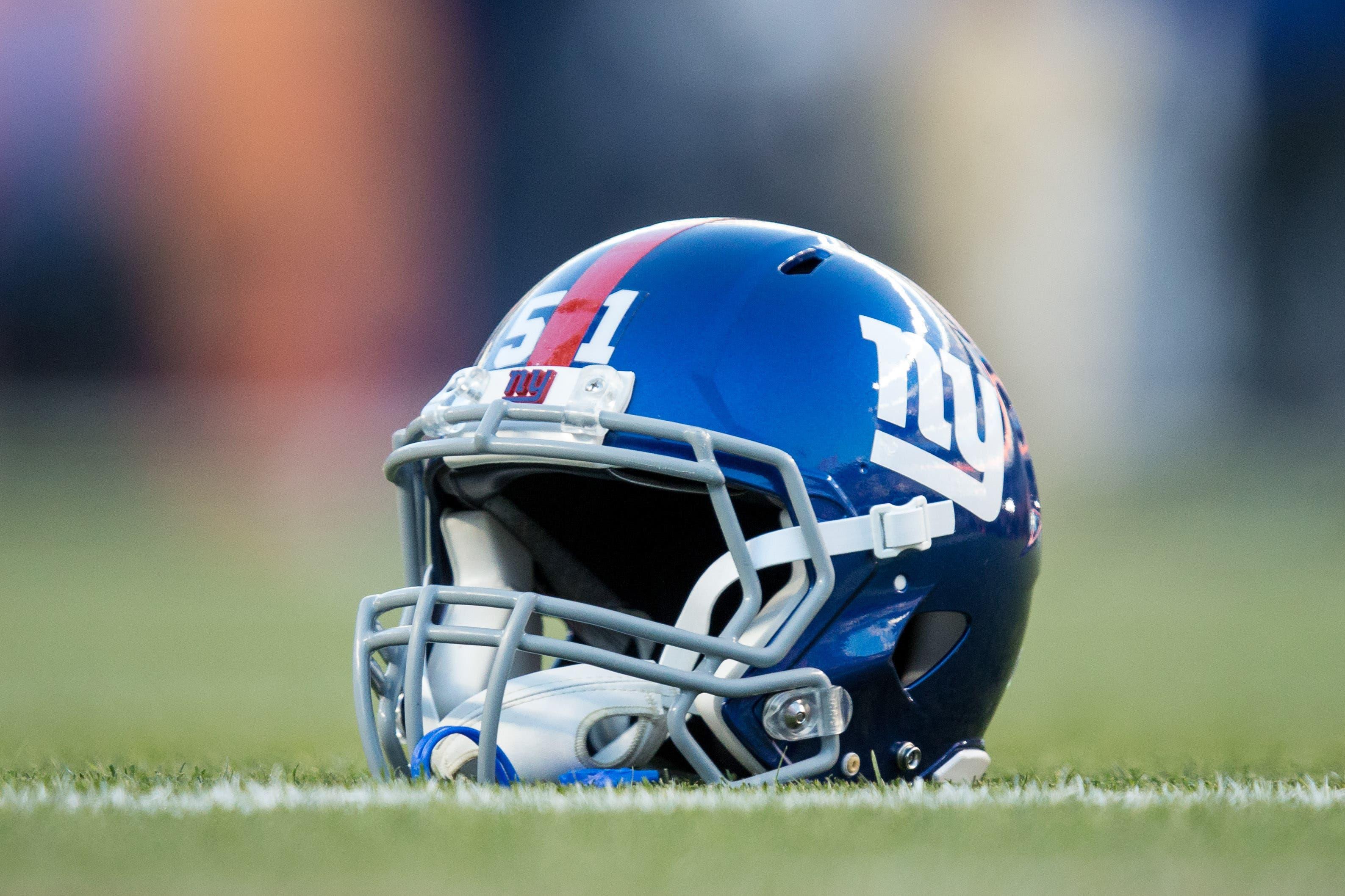 A general view of a New York Giants helmet on the turf before the game against the Denver Broncos at Sports Authority Field at Mile High. / Isaiah J. Downing-USA TODAY Sports