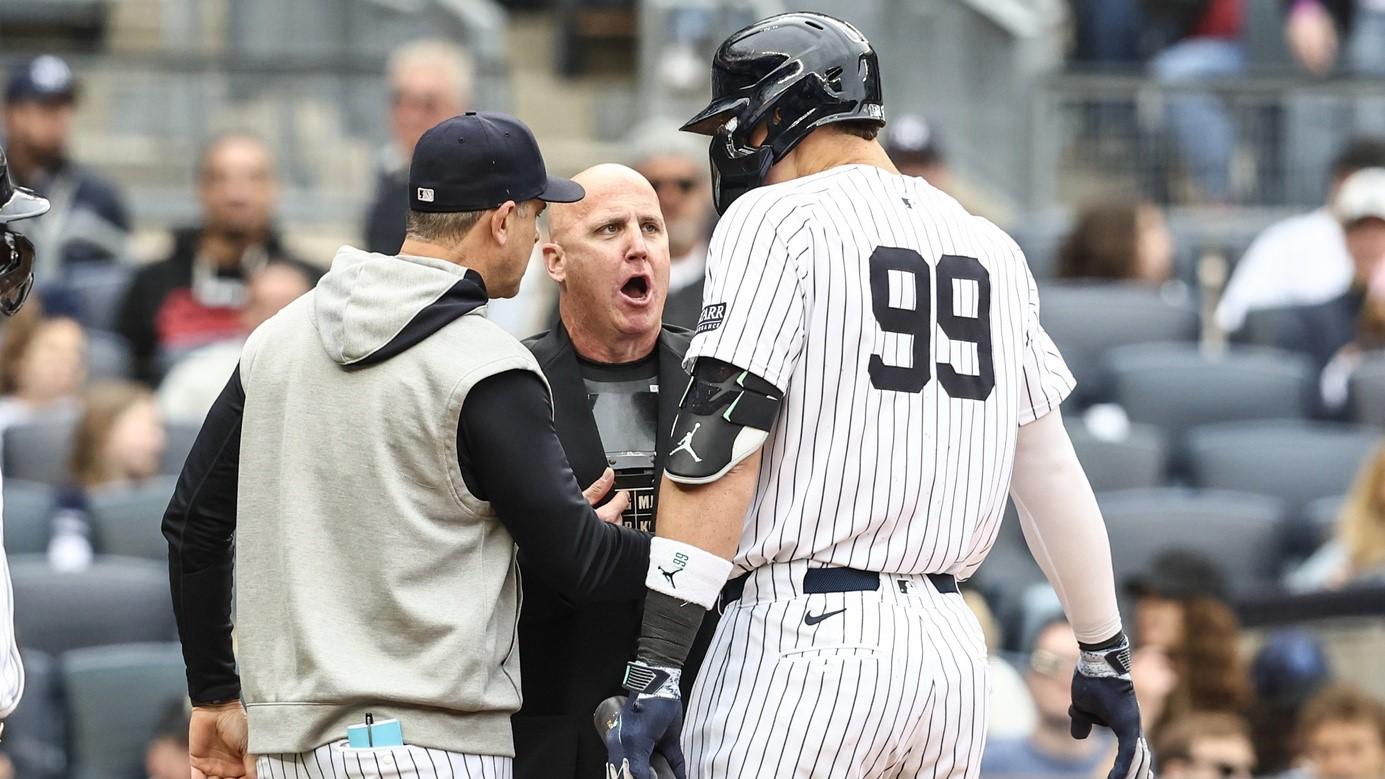 May 4, 2024; Bronx, New York, USA; New York Yankees center fielder Aaron Judge (99) and manager Aaron Boone (17) argue with home plate umpire Ryan Blakney (36) in the seventh inning against the Detroit Tigers at Yankee Stadium. / Wendell Cruz-USA TODAY Sports