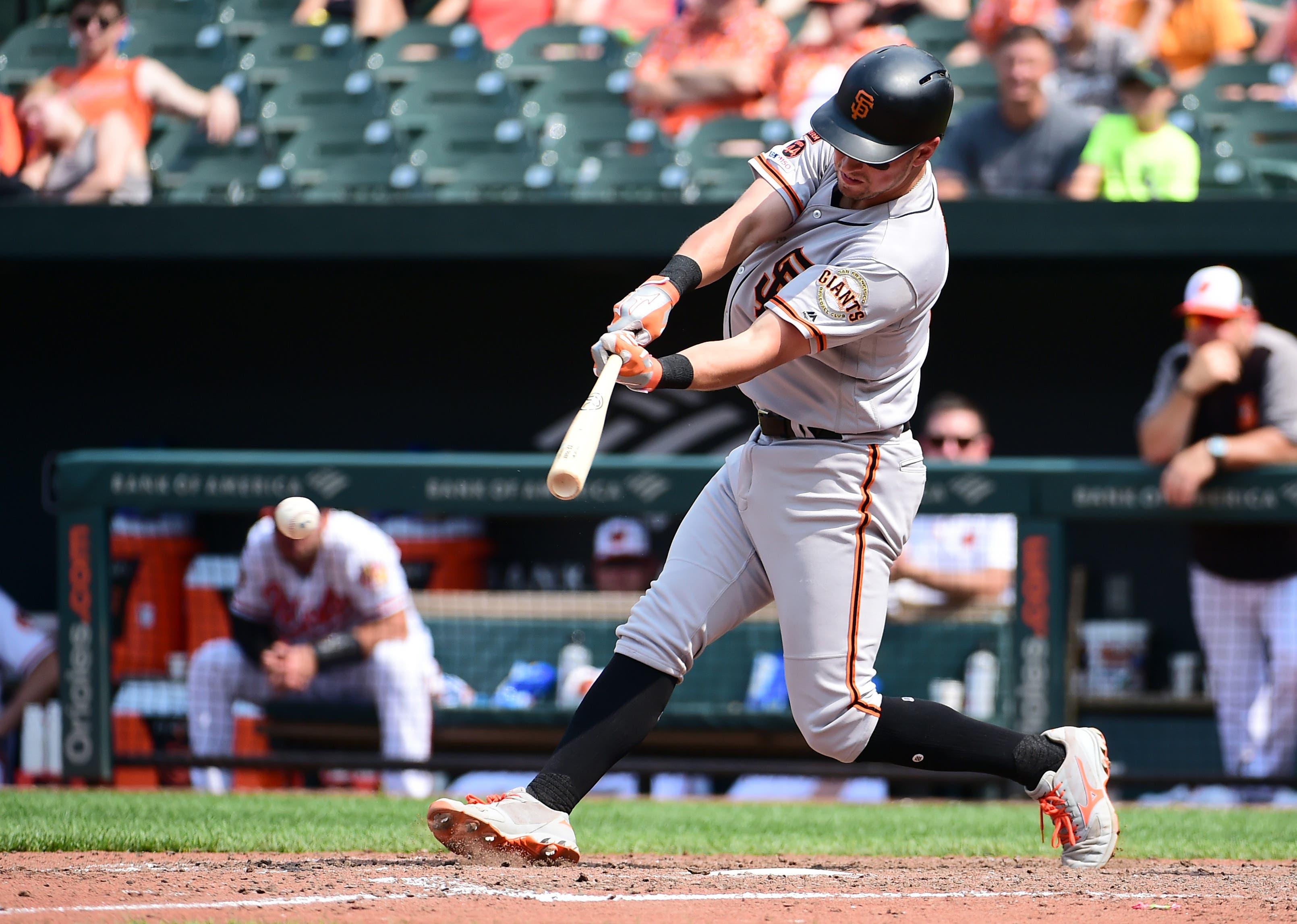 Jun 2, 2019; Baltimore, MD, USA; San Francisco Giants second baseman Joe Panik (12) hits an RBI single in the eighth inning against the Baltimore Orioles at Oriole Park at Camden Yards. Mandatory Credit: Evan Habeeb-USA TODAY Sports / Evan Habeeb