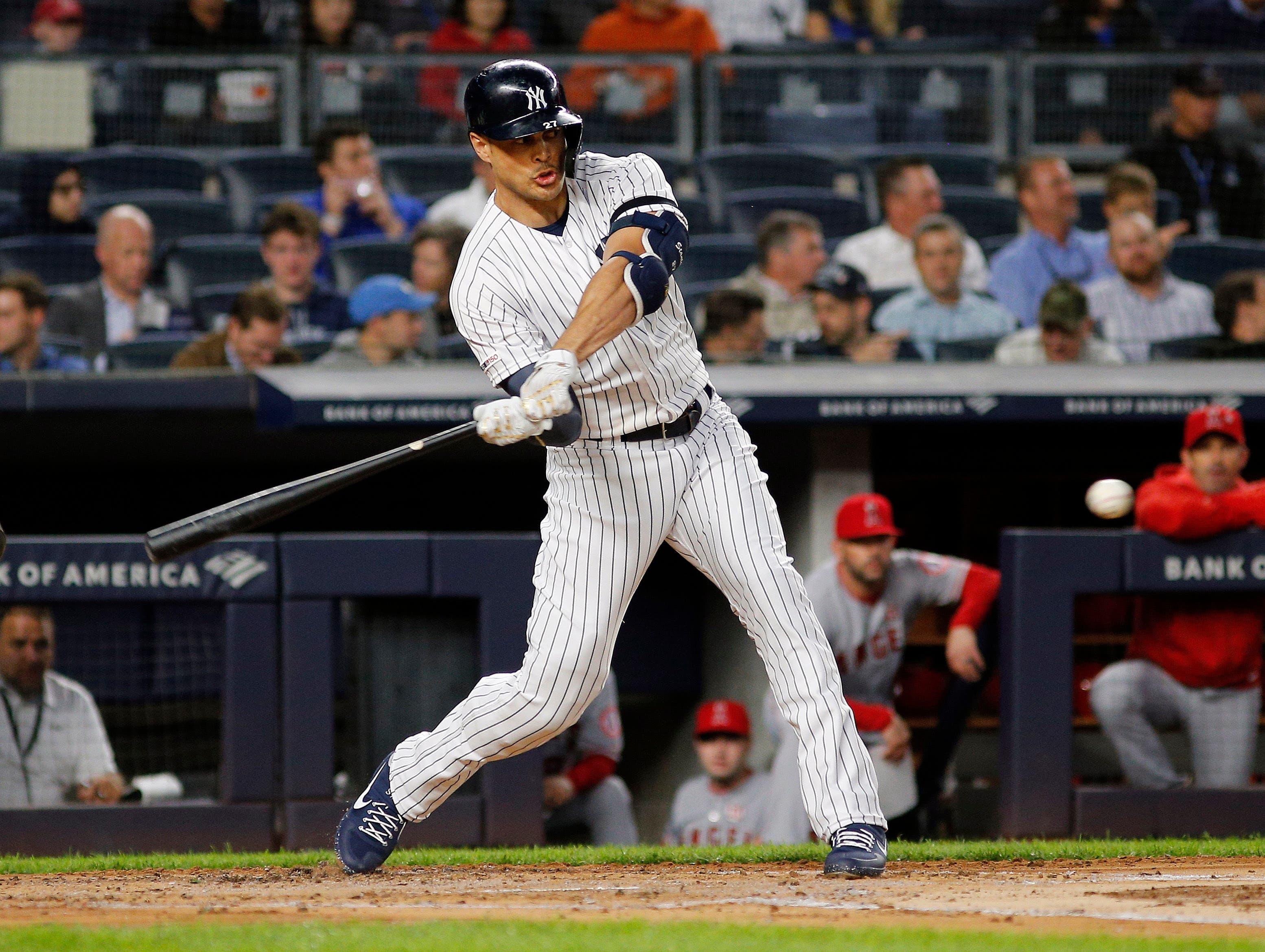 Sep 18, 2019; Bronx, NY, USA; New York Yankees left fielder Giancarlo Stanton (27) doubles against the Los Angeles Angels during the second inning at Yankee Stadium. Mandatory Credit: Andy Marlin-USA TODAY Sports / Andy Marlin