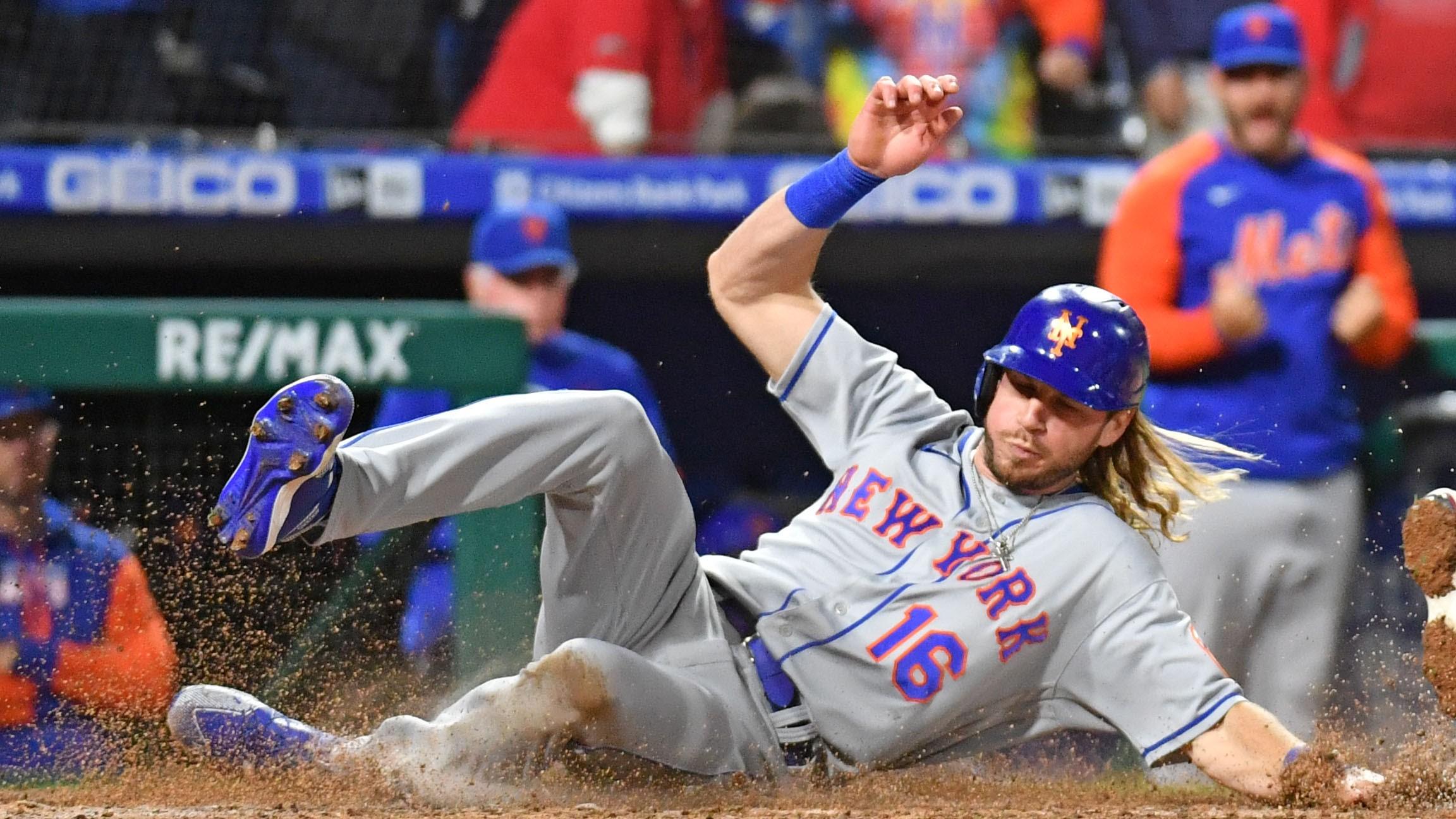 May 5, 2022; Philadelphia, Pennsylvania, USA; New York Mets center fielder Travis Jankowski (16) slides safely into home past Philadelphia Phillies catcher J.T. Realmuto (10) during the ninth inning at Citizens Bank Park. Mandatory Credit: Eric Hartline-USA TODAY Sports