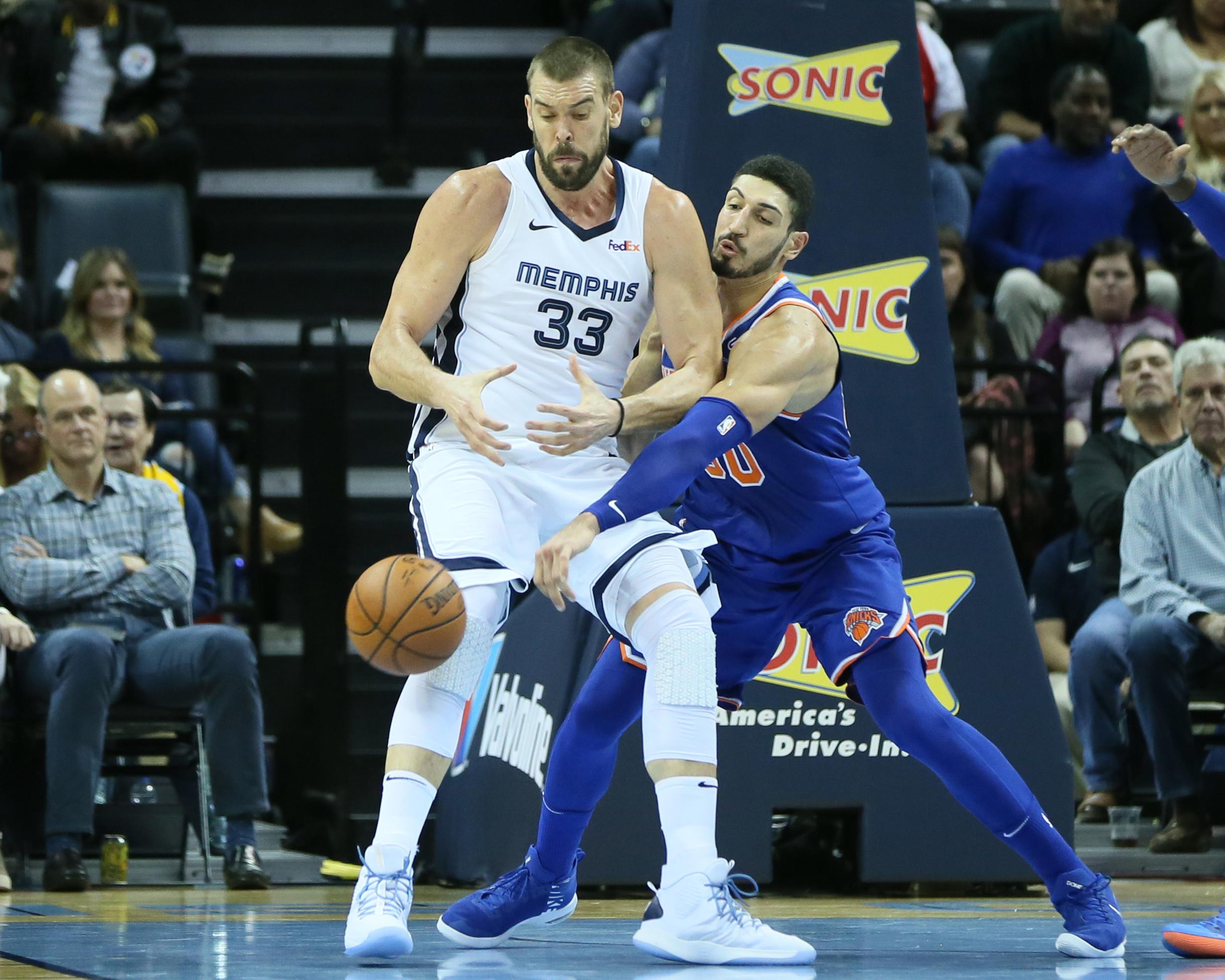 New York Knicks center Enes Kanter knocks the ball away from Memphis Grizzlies center Marc Gasol at FedExForum.