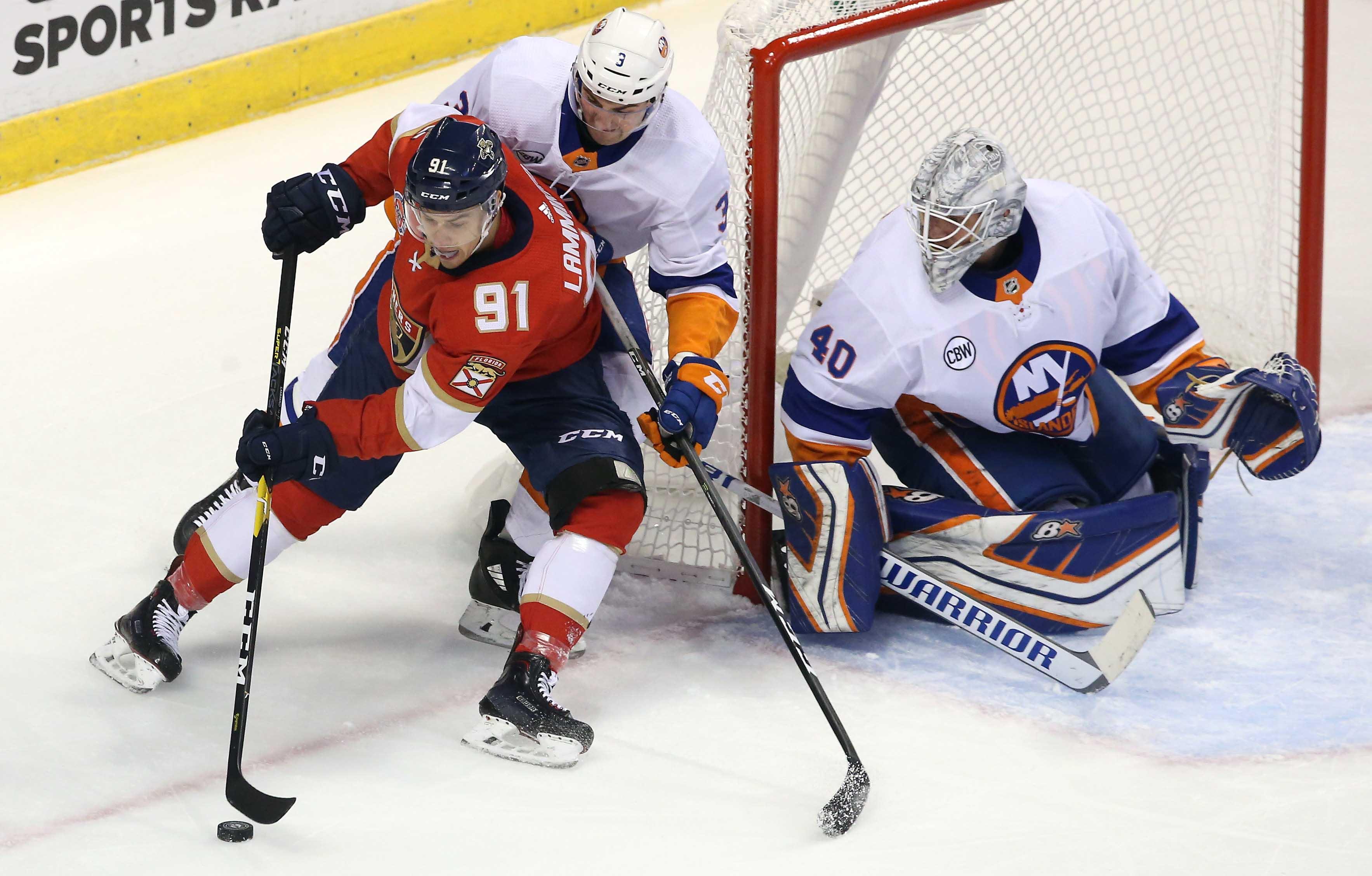 Nov 10, 2018; Sunrise, FL, USA; Florida Panthers right wing Juho Lammikko (91) skates with the puck around New York Islanders defenseman Adam Pelech (3) as goaltender Robin Lehner (40) looks on in the first period at BB&T Center. Mandatory Credit: Robert Mayer-USA TODAY Sports / Robert Mayer