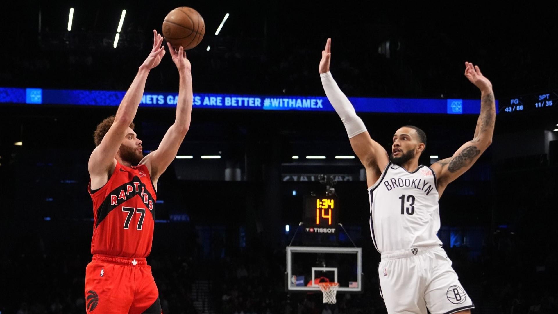 Oct 18, 2024; Brooklyn, New York, USA; Toronto Raptors forward Jamison Battle (77) shoots a three-point jump shot against Brooklyn Nets guard Tyrese Martin (13) during the second half at Barclays Center. 