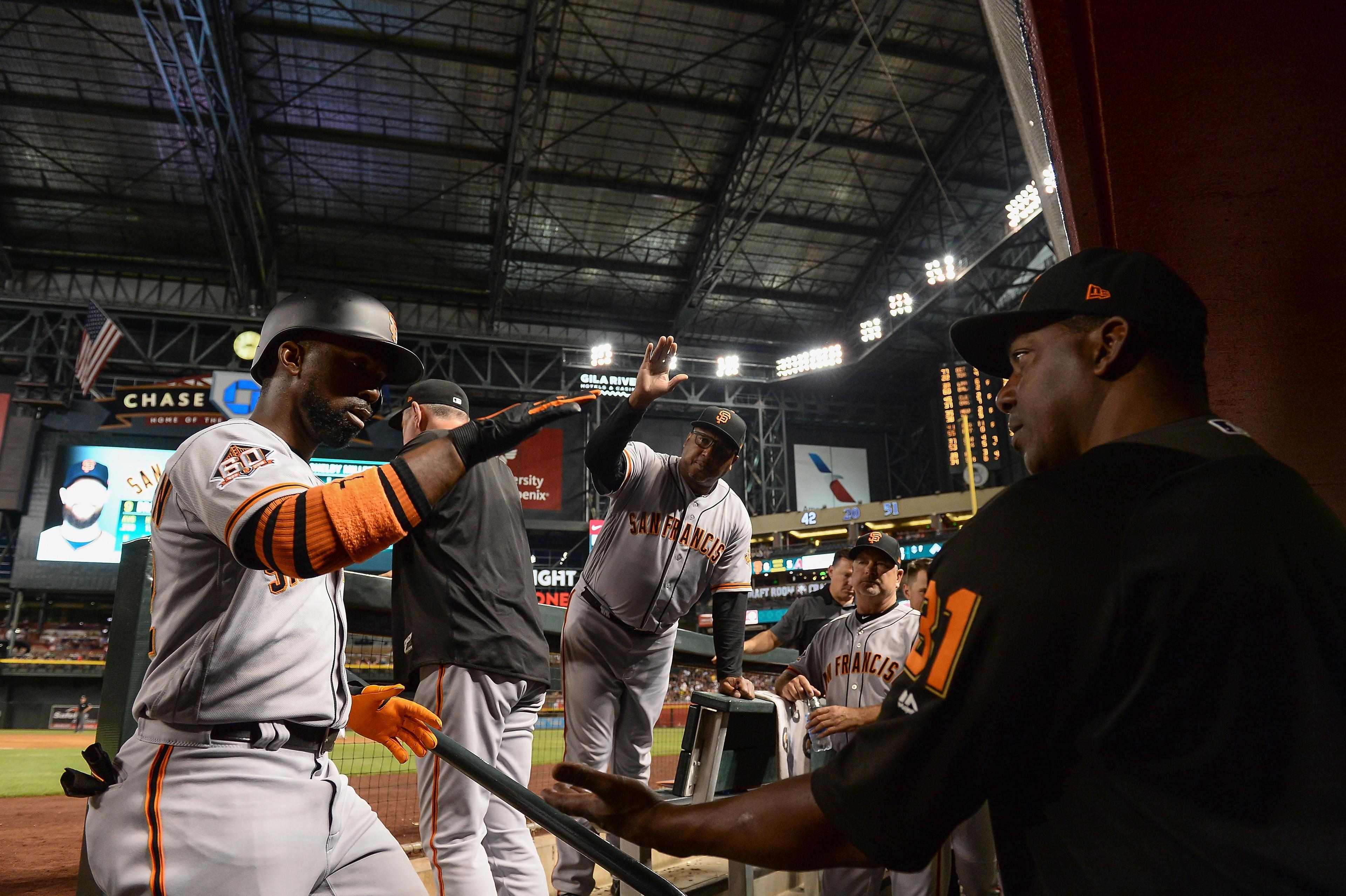 Jun 30, 2018; Phoenix, AZ, USA; San Francisco Giants outfielder Andrew McCutchen (left) is congratulated bench coach Hensley Meulens (31) after hitting a solo home run in the fourth inning against the Arizona Diamondbacks at Chase Field. Mandatory Credit: Jennifer Stewart-USA TODAY Sports 