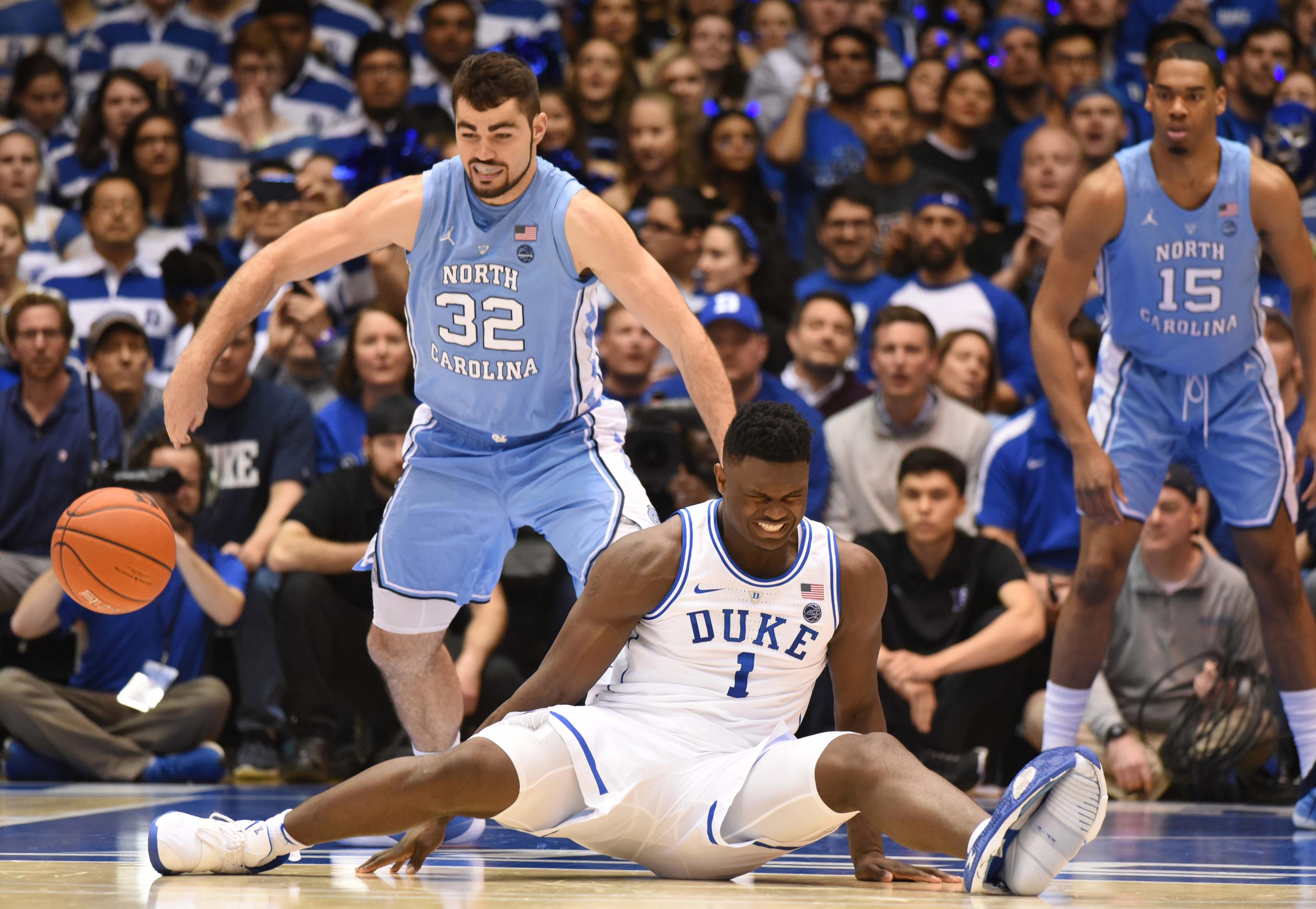 Feb 20, 2019; Durham, NC, USA; Duke Blue Devils forward Zion Williamson (1) reacts after falling while driving to the basket as North Carolina Tar Heels forward Luke Maye (32) defends during the first half at Cameron Indoor Stadium. Mandatory Credit: Rob Kinnan-USA TODAY Sports / Rob Kinnan