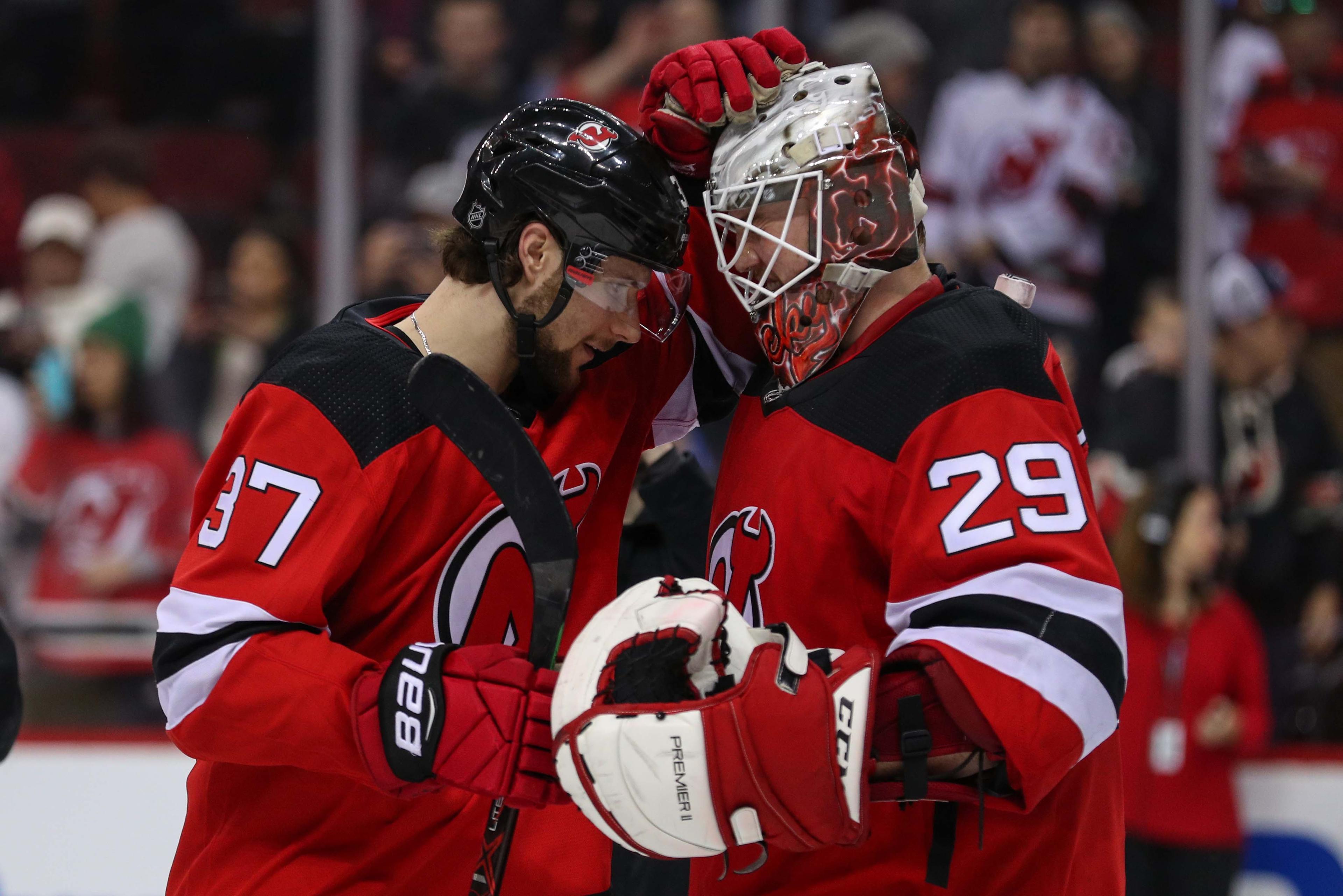 Dec 29, 2018; Newark, NJ, USA; New Jersey Devils center Pavel Zacha (37) and New Jersey Devils goaltender Mackenzie Blackwood (29) celebrate the Devils 2-0 win over the Hurricanes at Prudential Center. Blackwood recorded his first career NHL shutout. Mandatory Credit: Ed Mulholland-USA TODAY Sports / Ed Mulholland