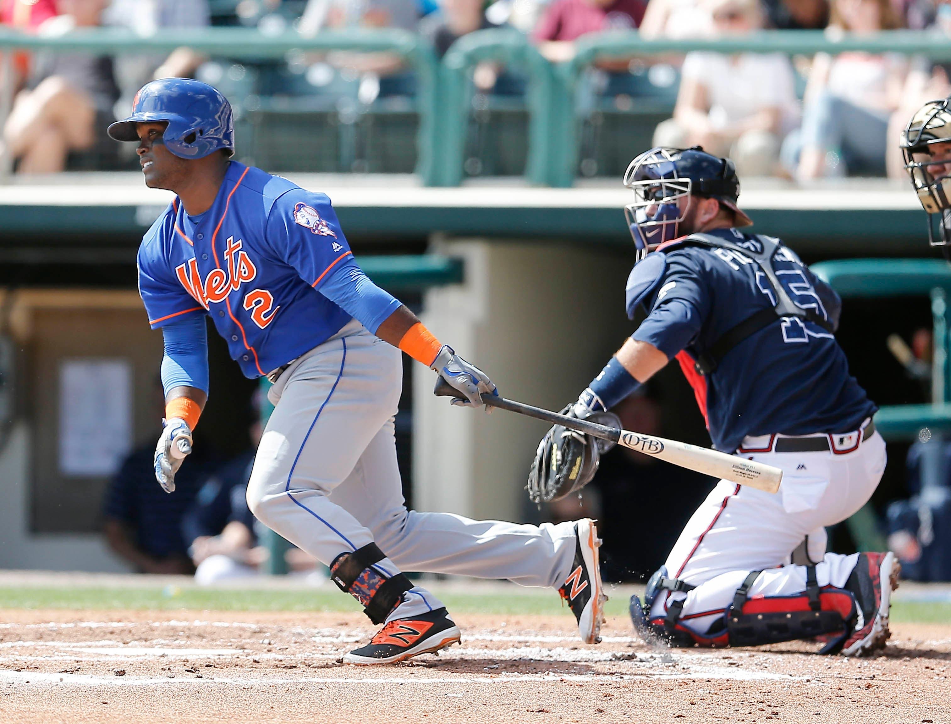 New York Mets second baseman Dilson Herrera runs to first as Atlanta Braves catcher A.J. Pierzynski looks on during the third inning of a spring training baseball game at Champion Stadium. / Reinhold Matay/USA Today Sports Images