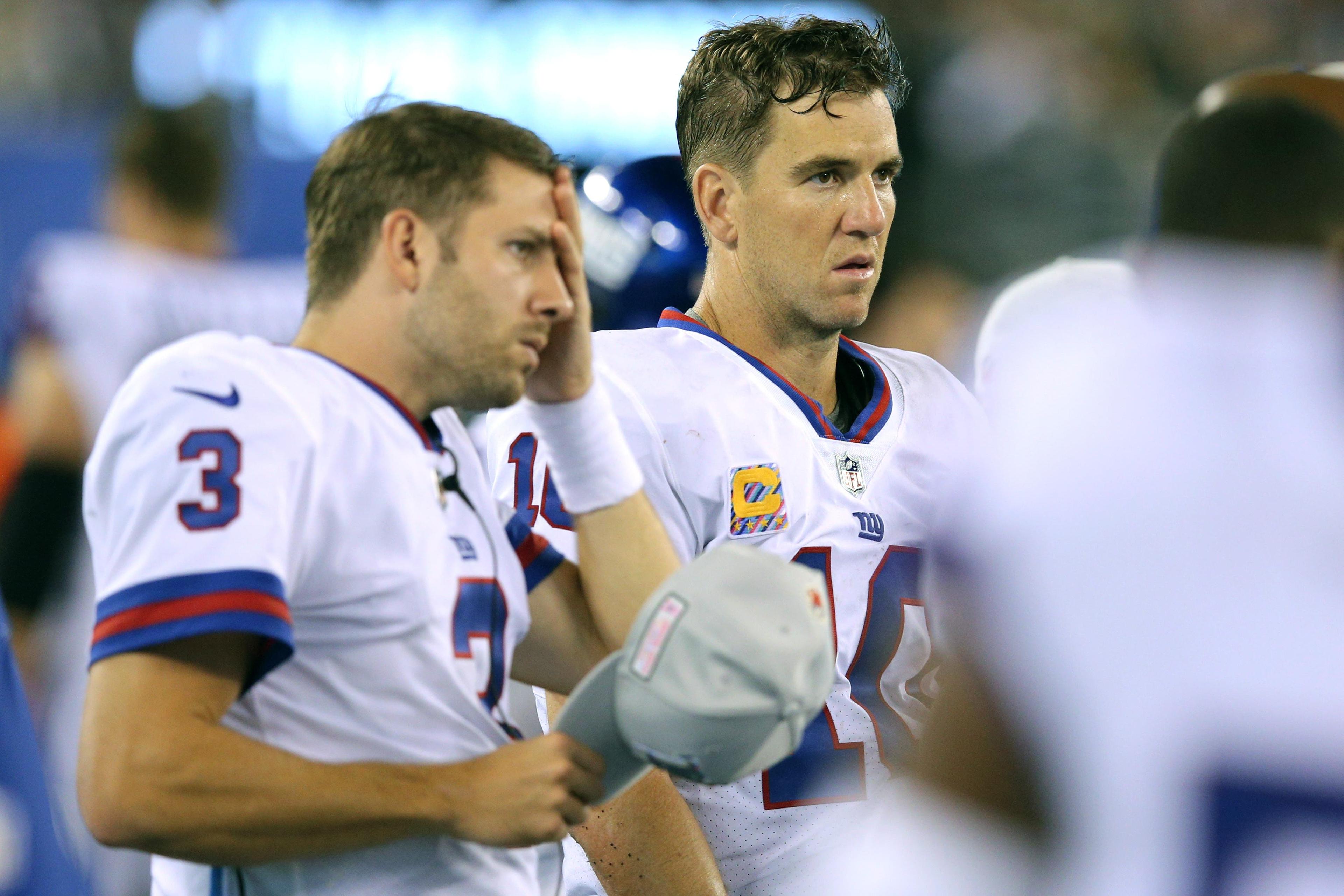 Oct 11, 2018; East Rutherford, NJ, USA; New York Giants quarterback Alex Tanney (3) and quarterback Eli Manning (10) look on from the sidelines late during the fourth quarter against the Philadelphia Eagles at MetLife Stadium. Mandatory Credit: Brad Penner-USA TODAY Sports / Brad Penner