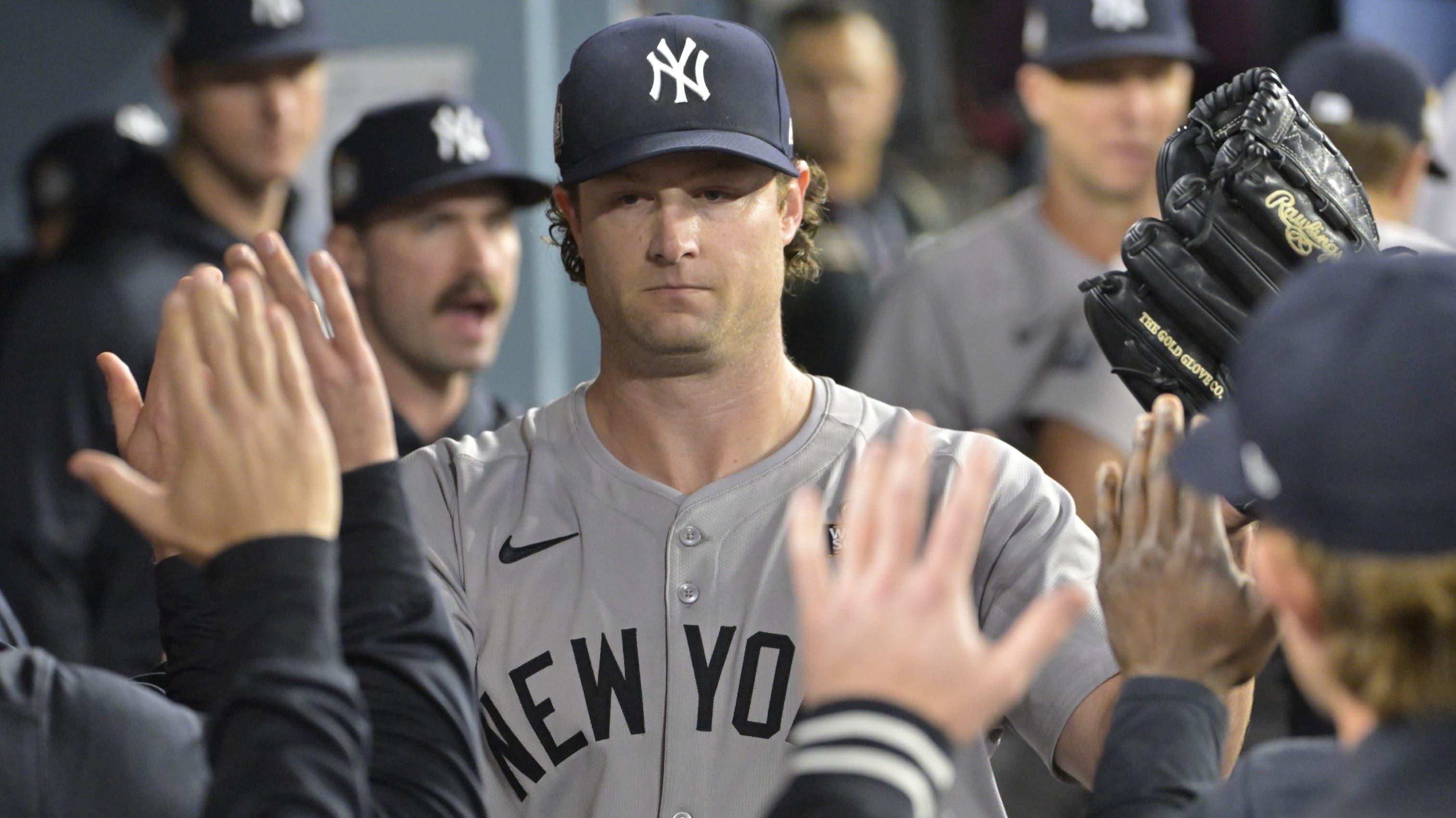 Oct 25, 2024; Los Angeles, California, USA; New York Yankees starting pitcher Gerrit Cole (45) receives congratulations in the dugout in the seventh inning against the Los Angeles Dodgers during game one of the 2024 MLB World Series at Dodger Stadium.