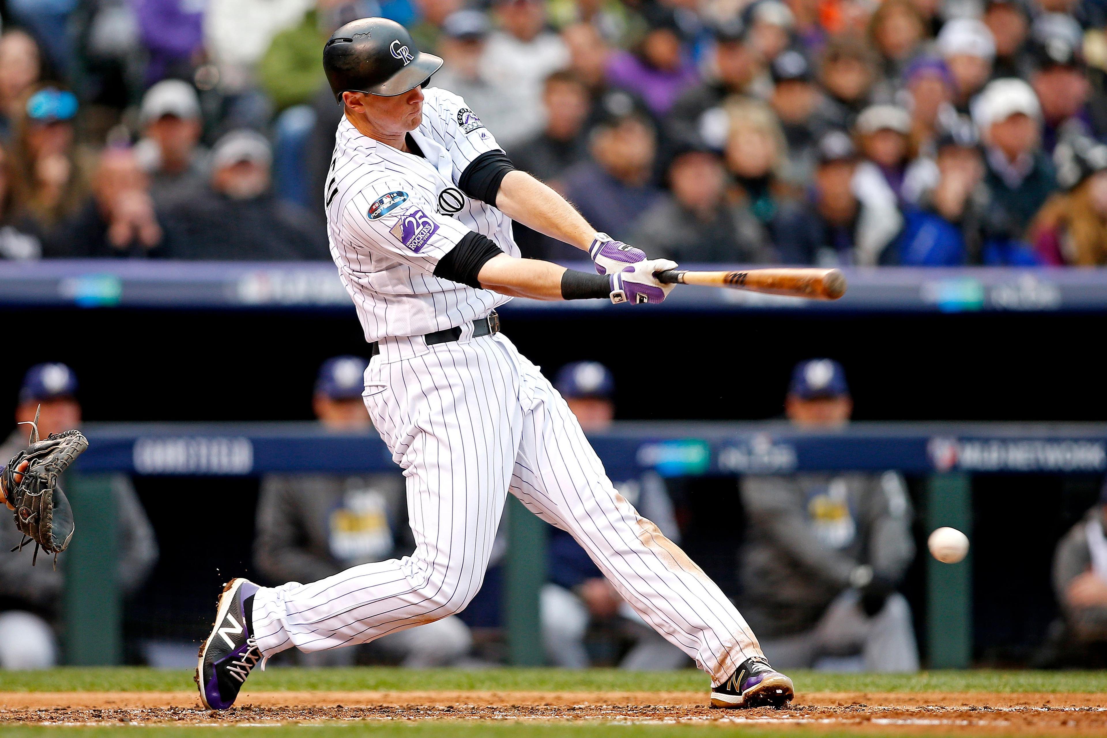 Oct 7, 2018; Denver, CO, USA; Colorado Rockies second baseman DJ LeMahieu (9) hits a double during the third inning against the Milwaukee Brewers in game three of the 2018 NLDS playoff baseball series at Coors Field. Mandatory Credit: Russell Lansford-USA TODAY Sports / Russell Lansford