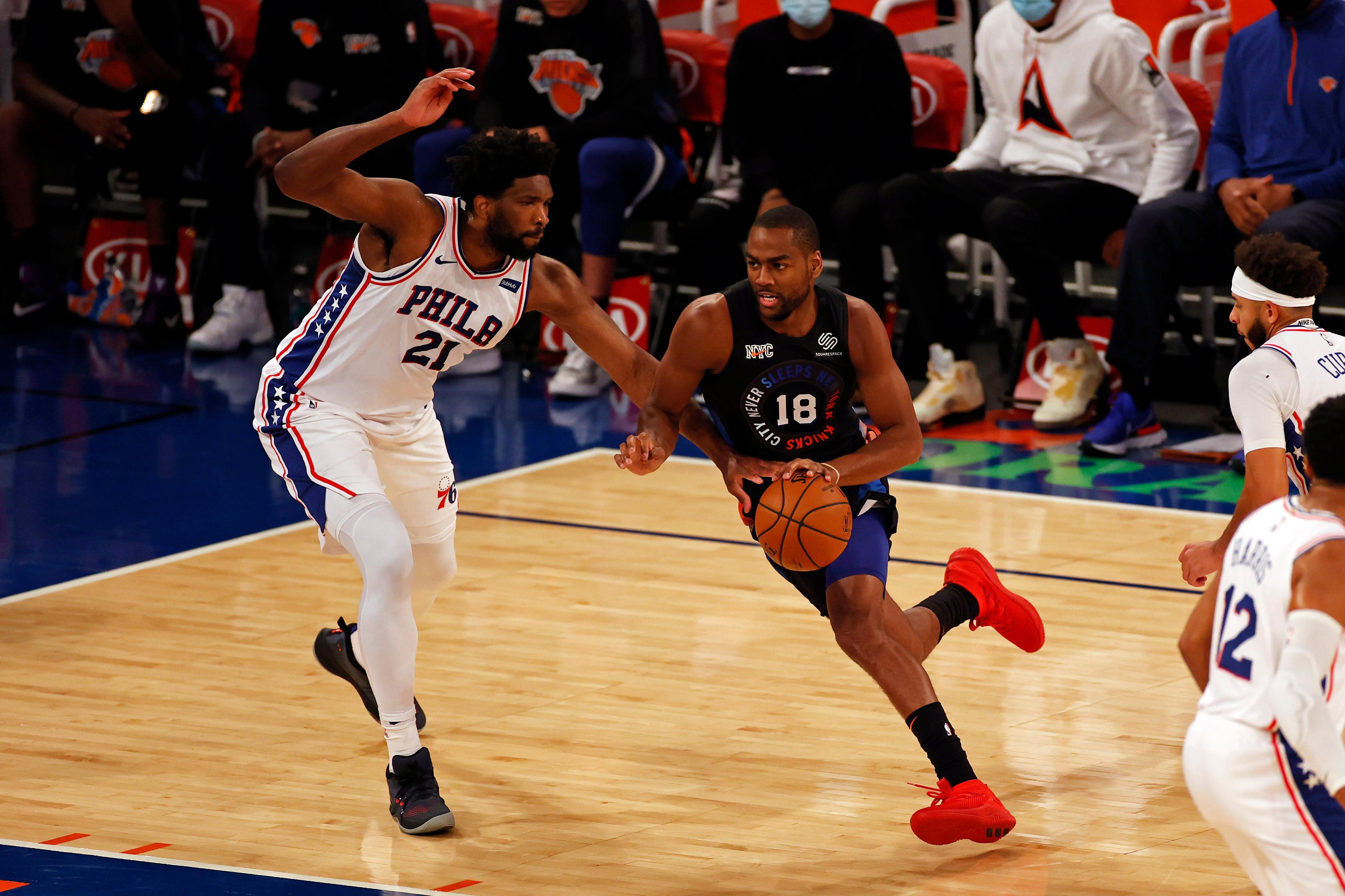 Dec 26, 2020; New York, New York, USA; New York Knicks guard Alec Burks (18) drives to the basket past Philadelphia 76ers center Joel Embiid (21) during the first half of an NBA basketball game Saturday, Dec. 26, 2020, in New York. The 76ers defeated the Knicks 109-89 at Madison Square Garden. / © POOL PHOTOS-USA TODAY Sports